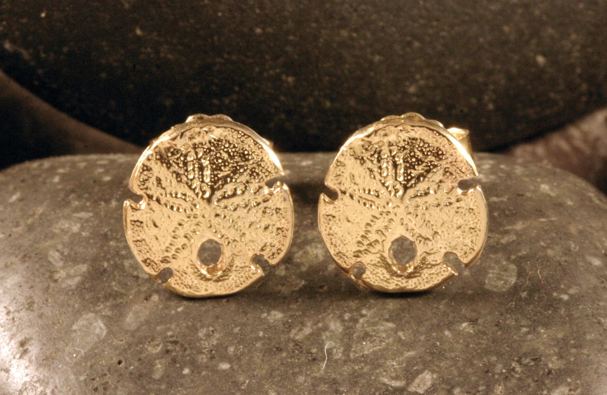 A front view of 14K gold mini sanddollar stud earrings.
