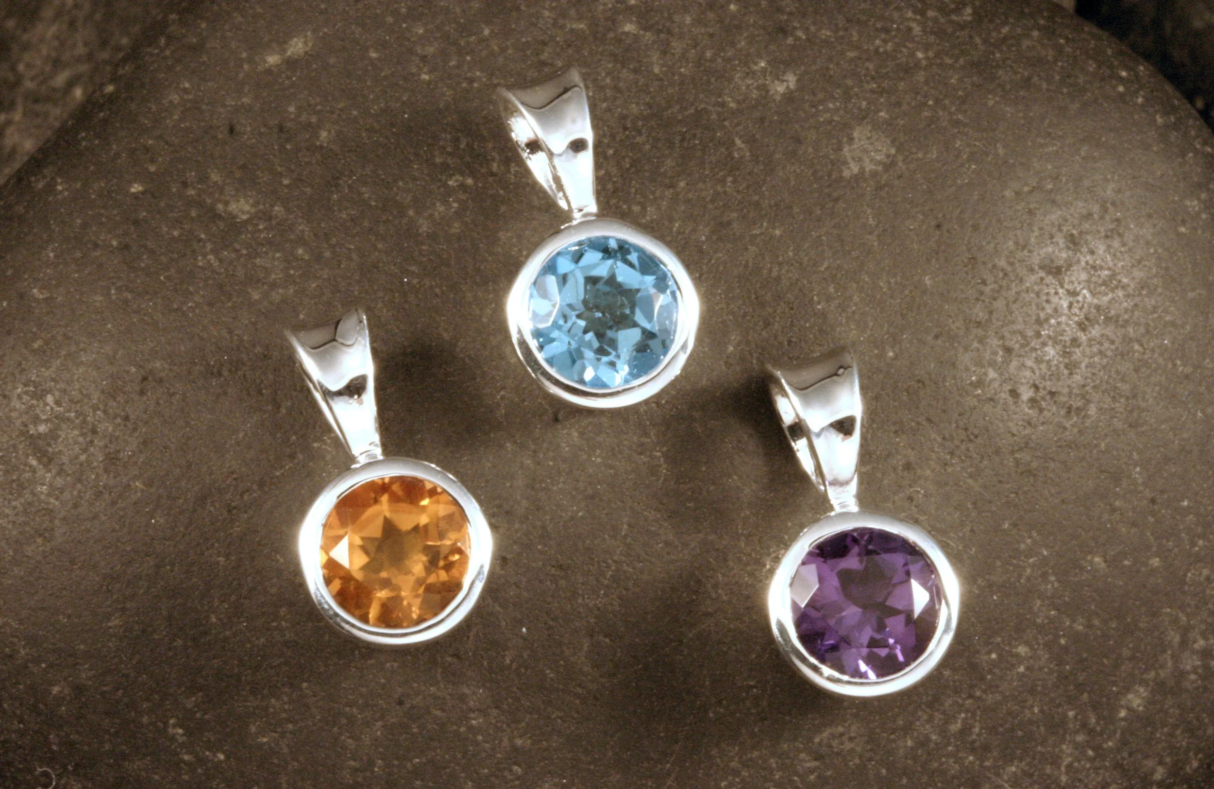 Sterling silver bezel set gemstone pendants with citrine, swiss blue topaz, and amethyst.