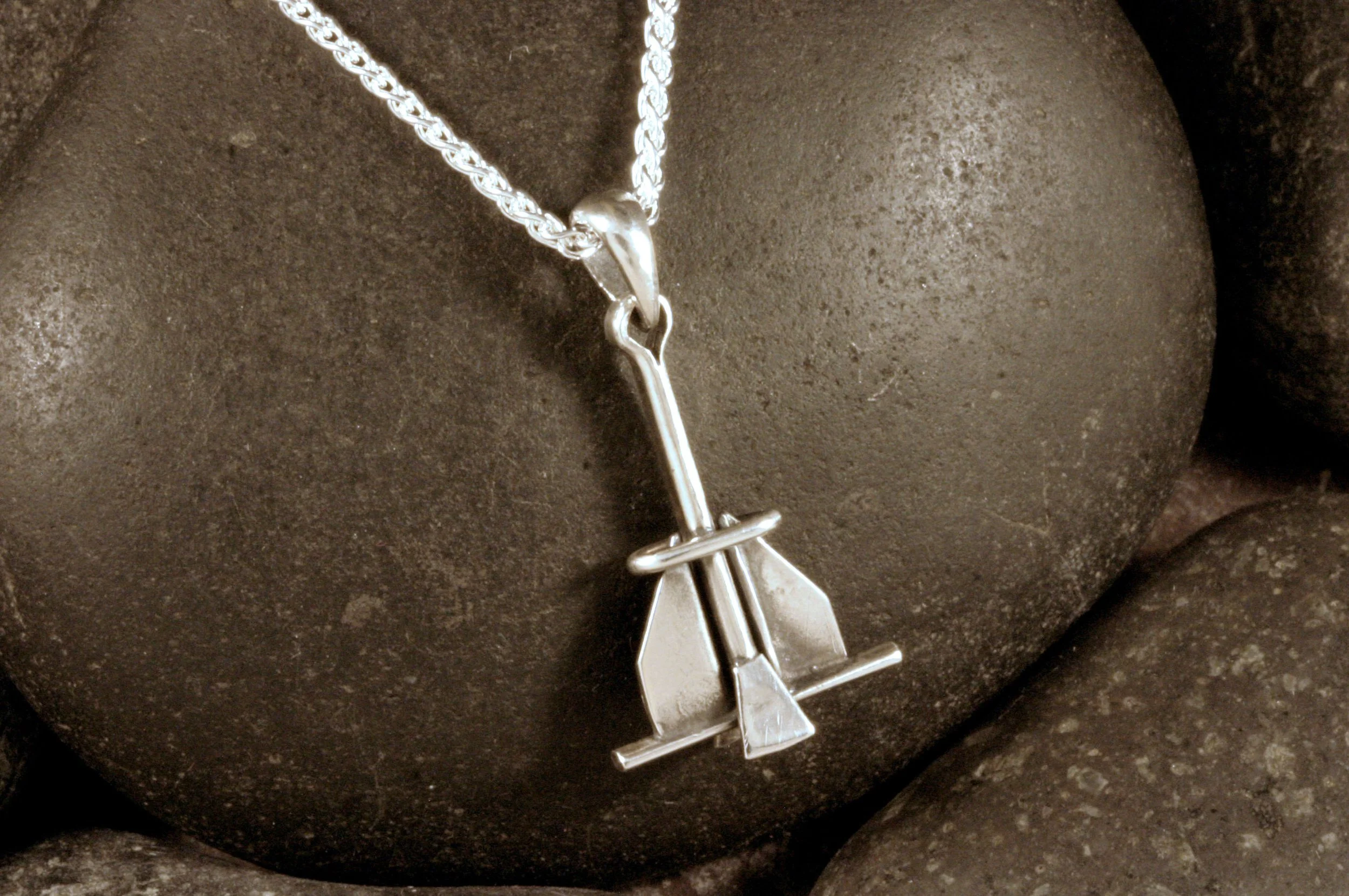 An oxidized sterling silver danforth fluke anchor pendant shown on a spiga chain that is sold separately.