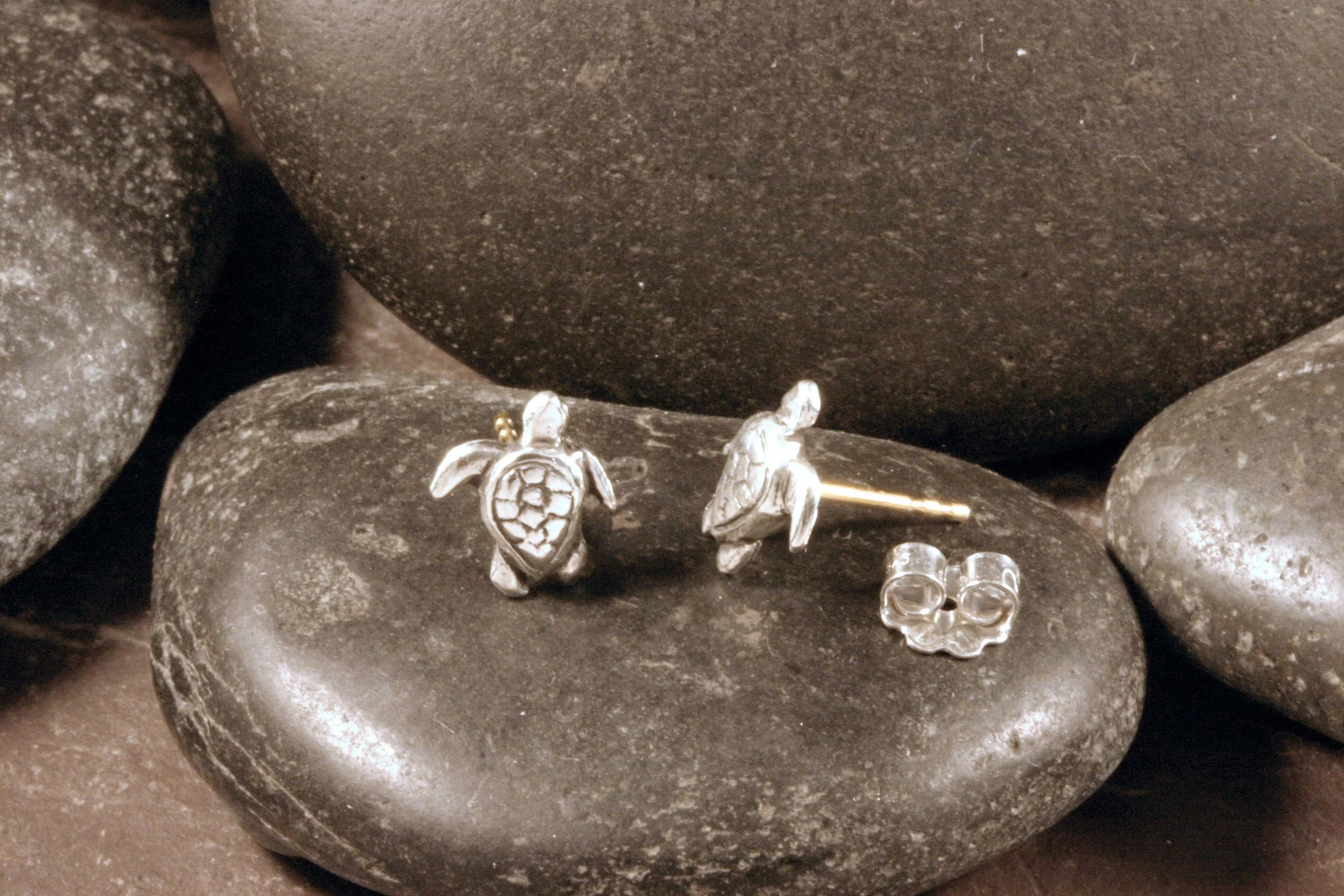 Sterling silver mini turtle stud earrings with a front & side view to show its 14K gold hypoallergenic post and sterling silver butterfly back.