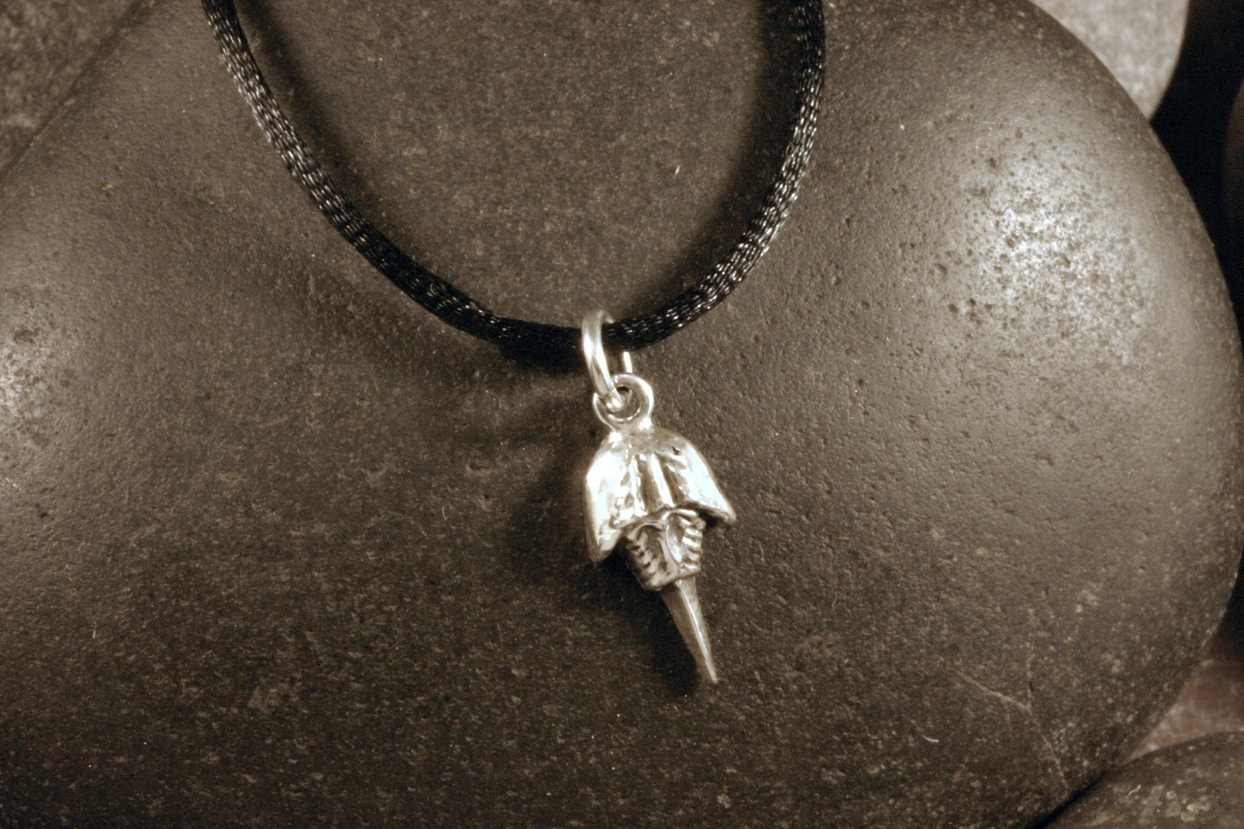 An oxidized sterling silver mini horseshoe crab charm.