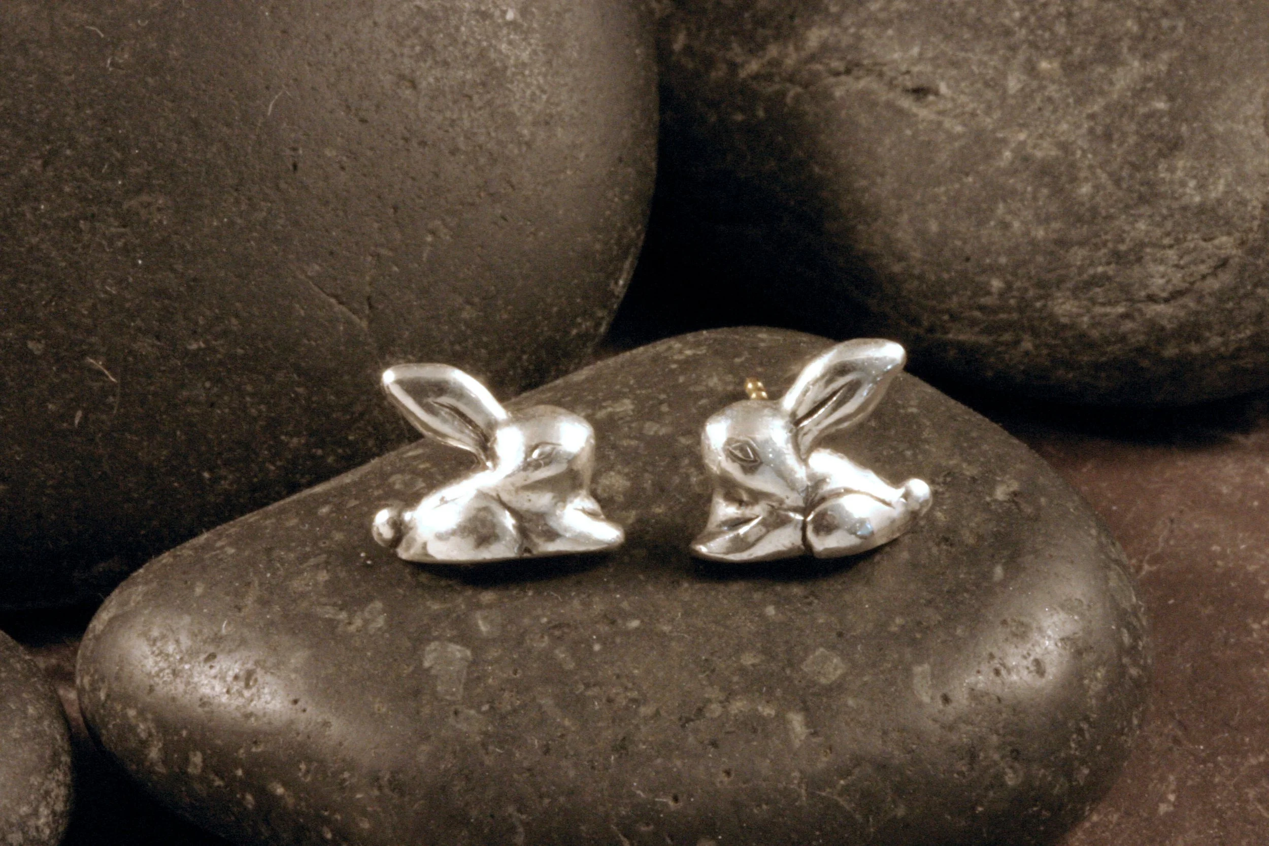 A front view of sterling silver stylized bunny rabbit stud earrings.