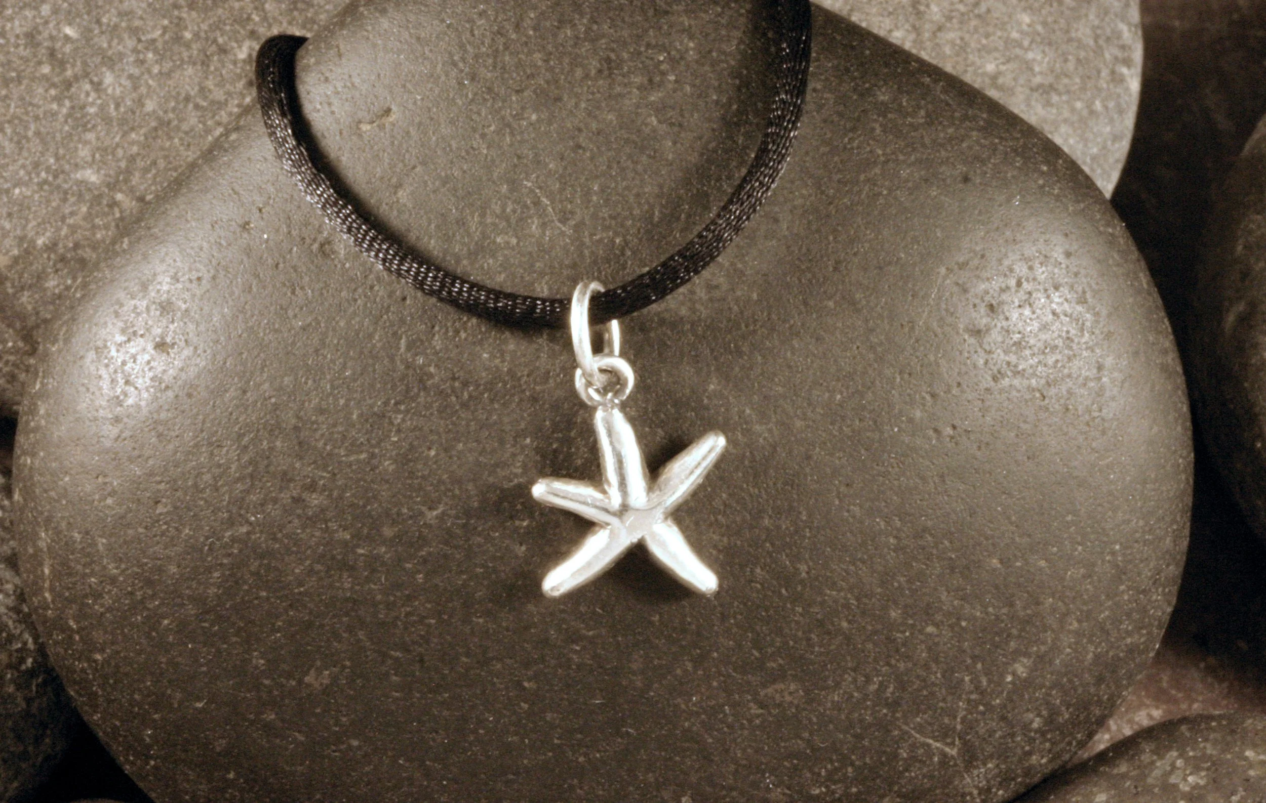 A small sterling silver dancing starfish charm.