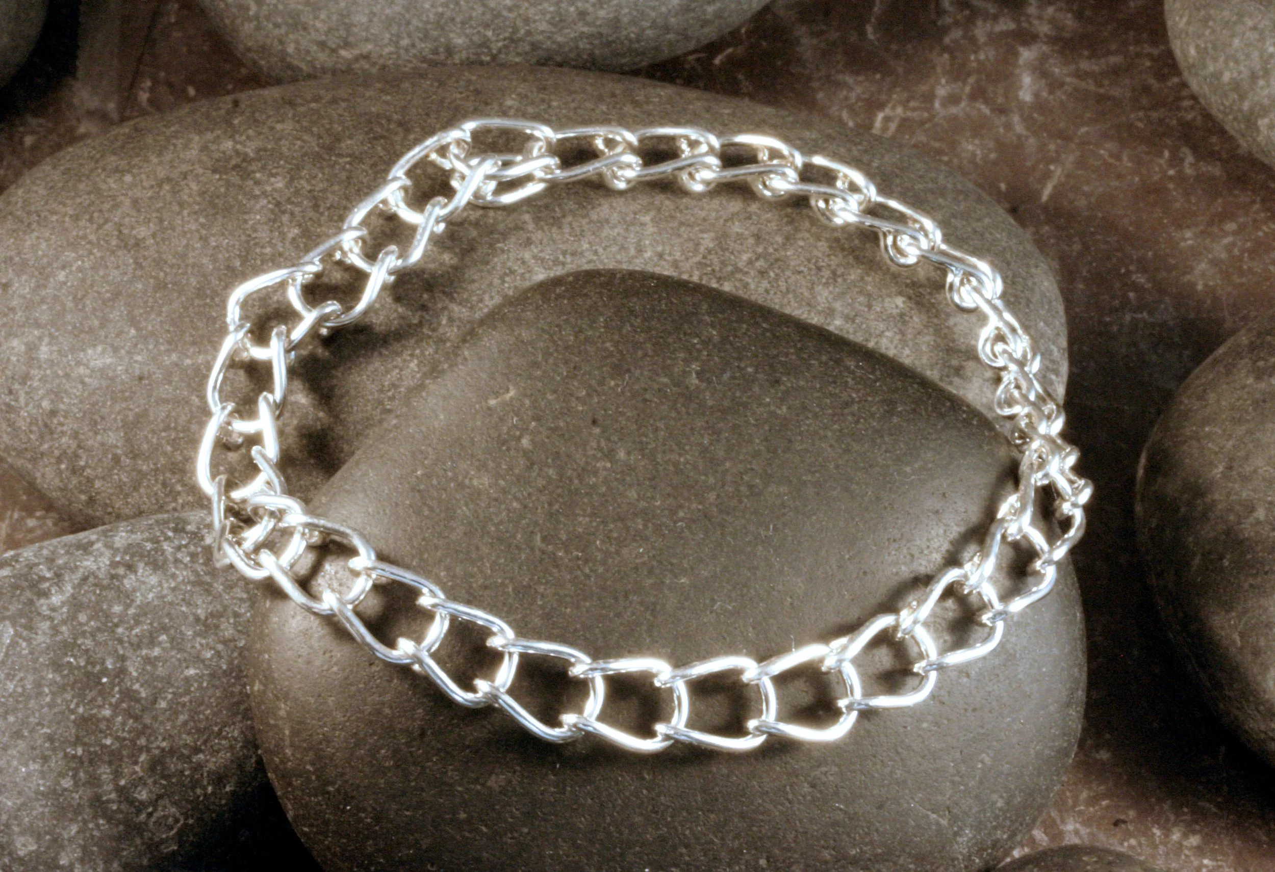 A sterling silver horseshoe shaped U link chain bracelet with a full view.