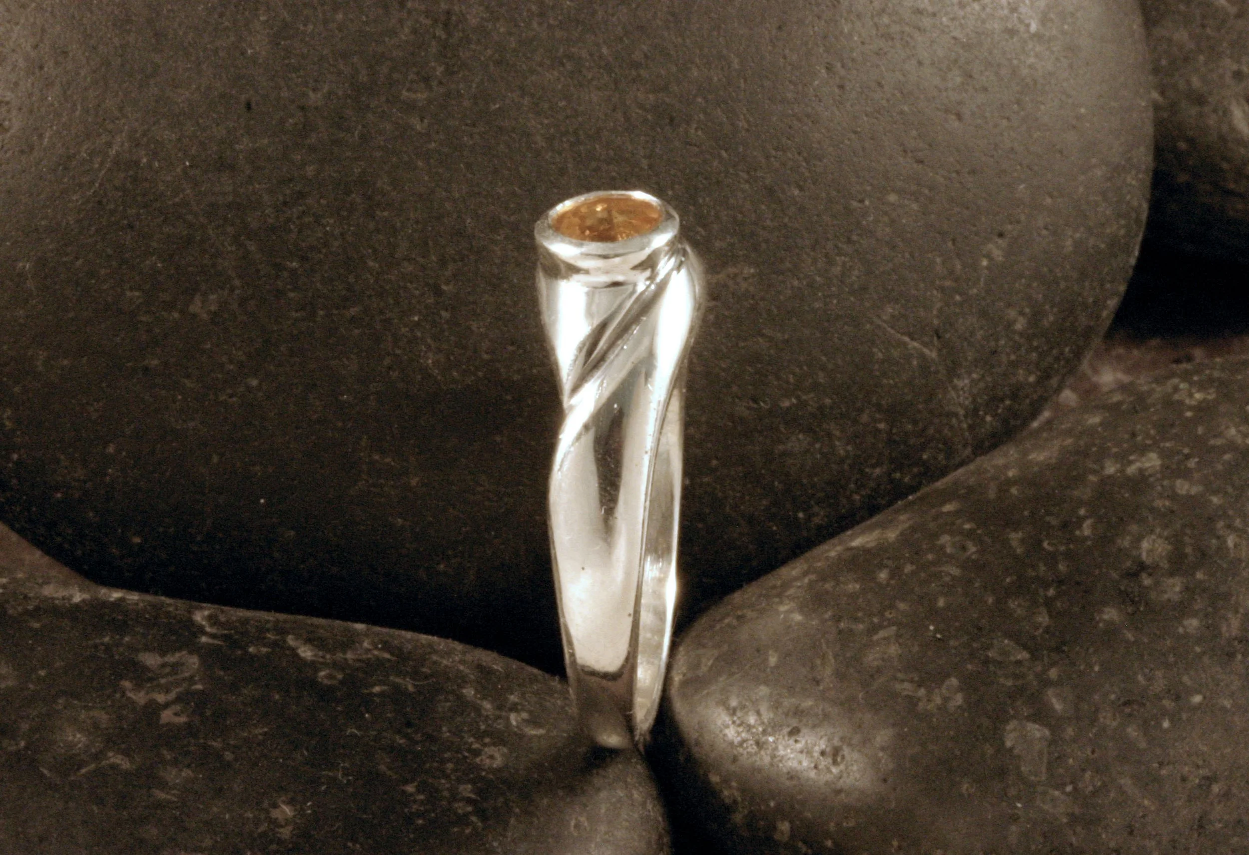 A side view of a sterling silver citrine organic v ring.