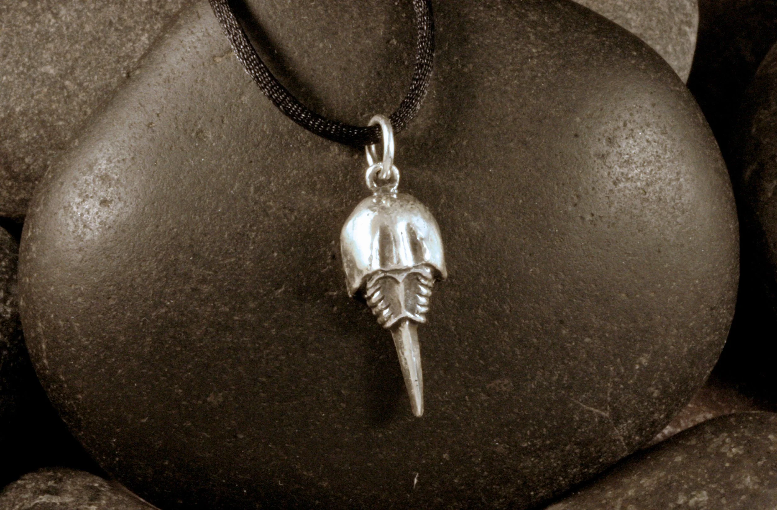 An oxidized sterling silver horseshoe crab charm with a stationary tail.