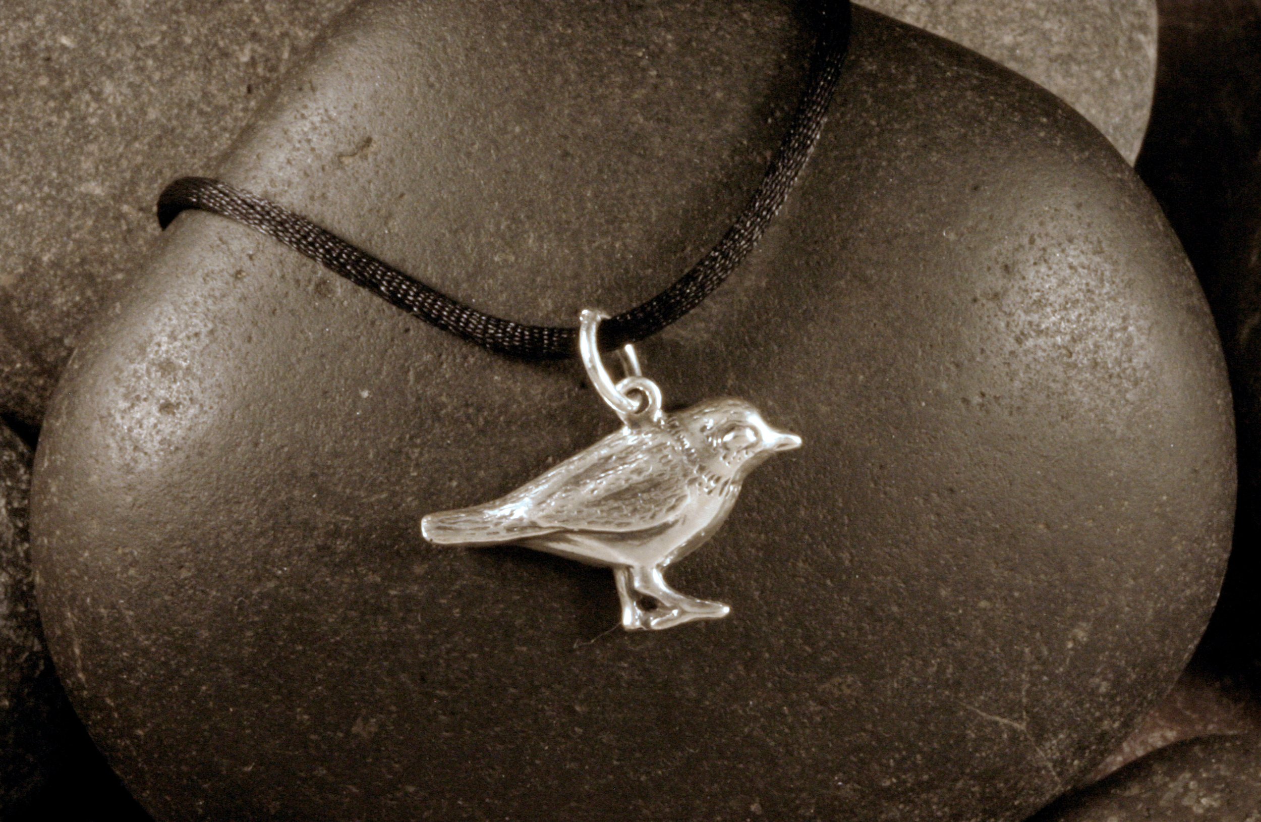 A left side sterling silver standing piping plover charm.