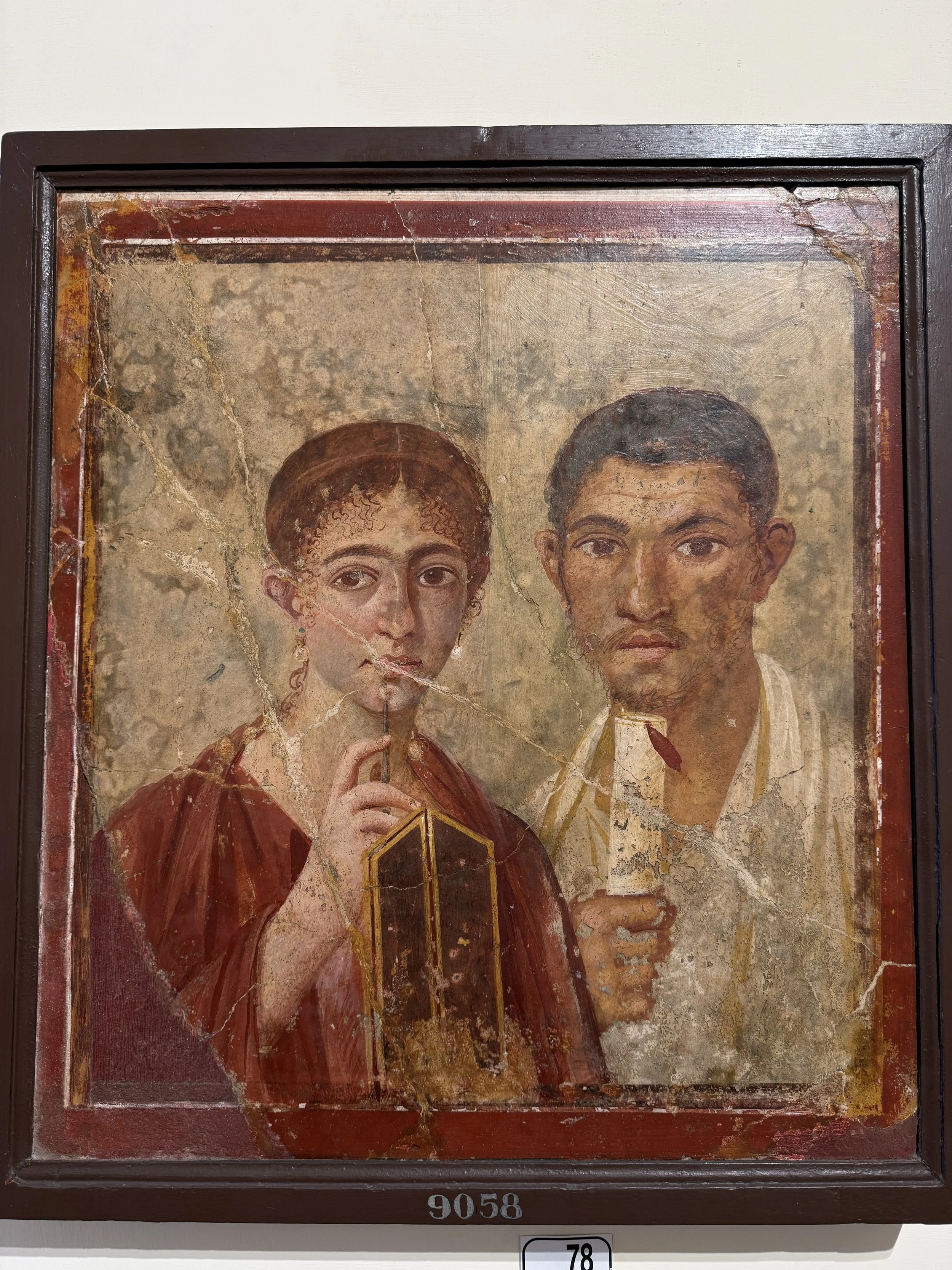 A damaged religious icon painting depicting two young figures with dark hair, one with a staff, framed in wood, numbered 9058.