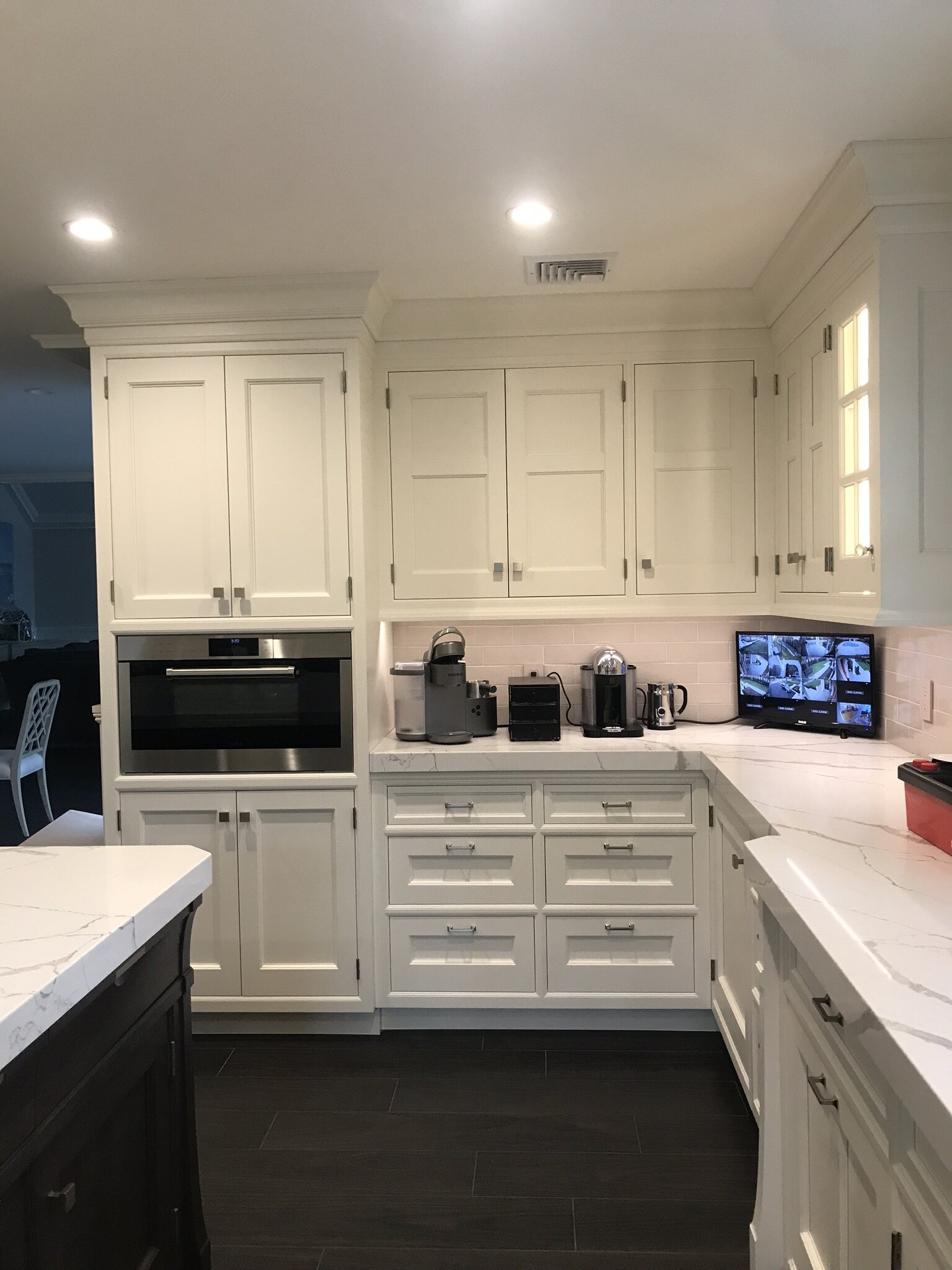 Rutt custom traditional cabinetry in white paint and dark wood stain. .
