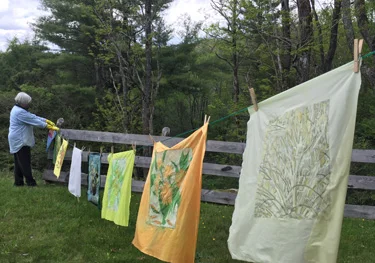 batiks hanging to dry between dyes