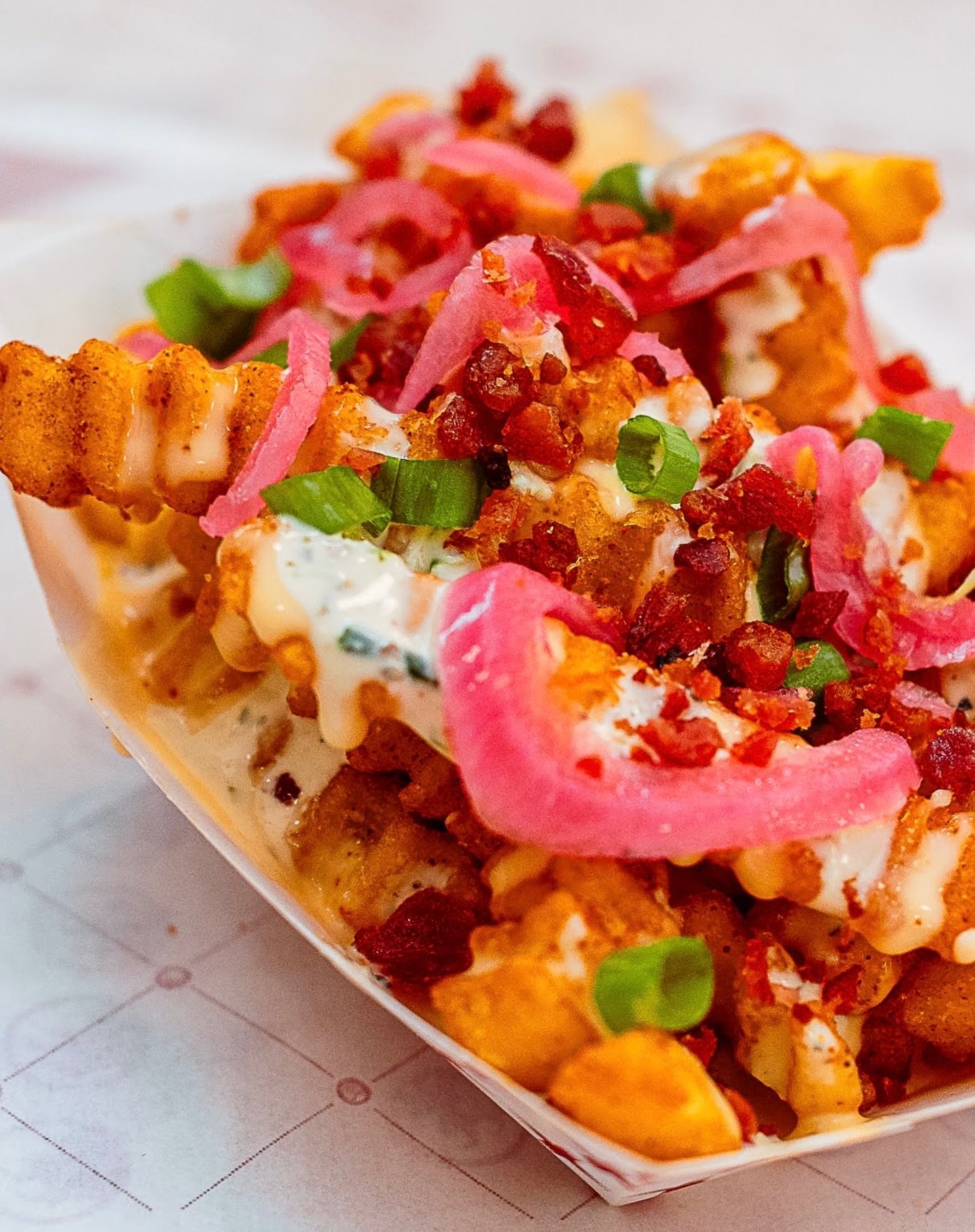 Seasoned crinkle-cut fries are our standard&hellip;but loading them with melted house cheese, bacon, and pickled red onions is how you handle a craving. It takes five seconds to make the decision at the register and about one minute to realize it was