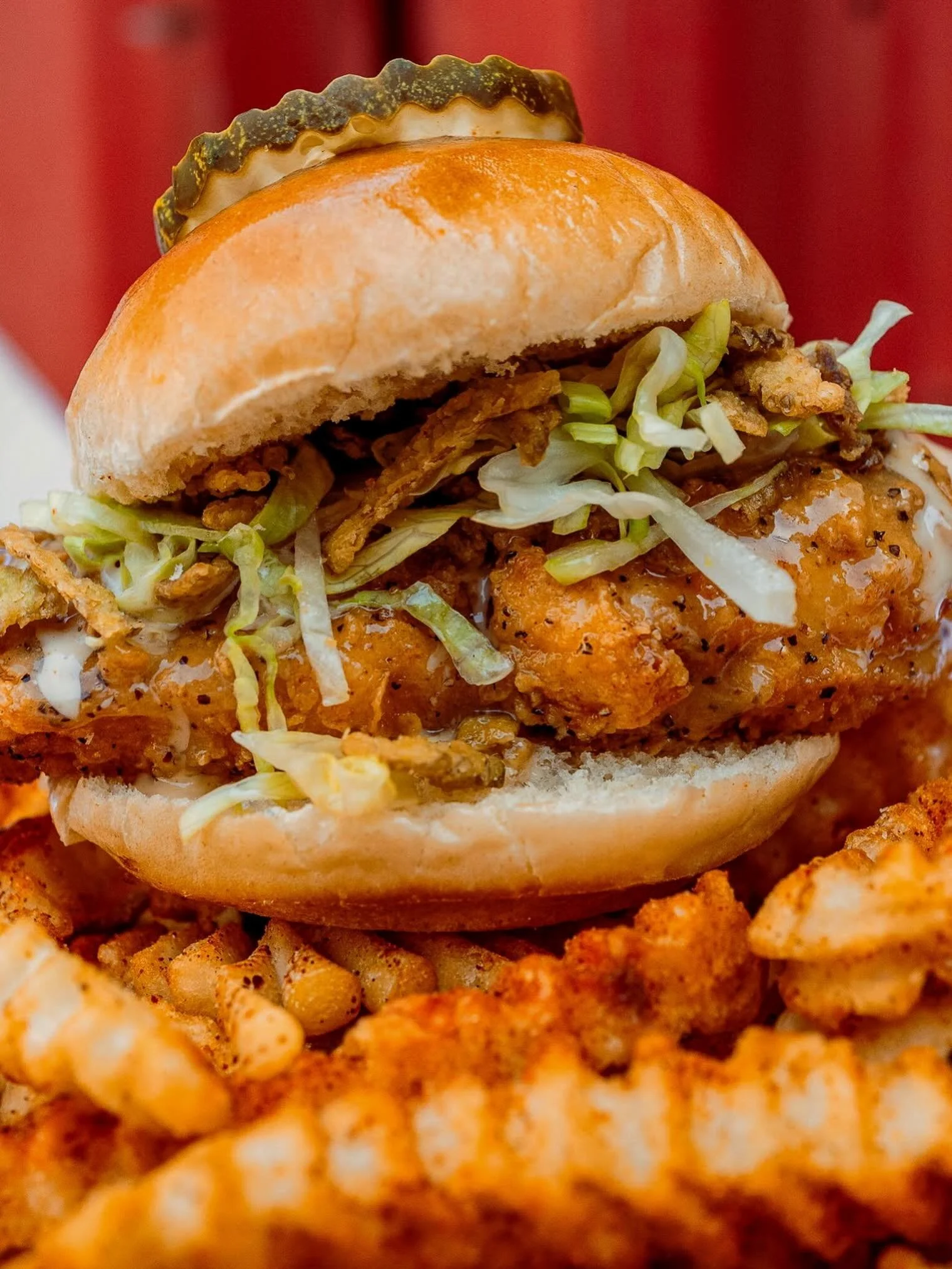 Slider of the Month: Lemon Pepper!

Two crispy tenders dunked in our house lemon pepper sauce, stacked on toasted potato buns with Alabama white BBQ sauce, shredded lettuce, and crispy jalape&ntilde;o chips. It&rsquo;s citrusy, peppery, and a flavor 