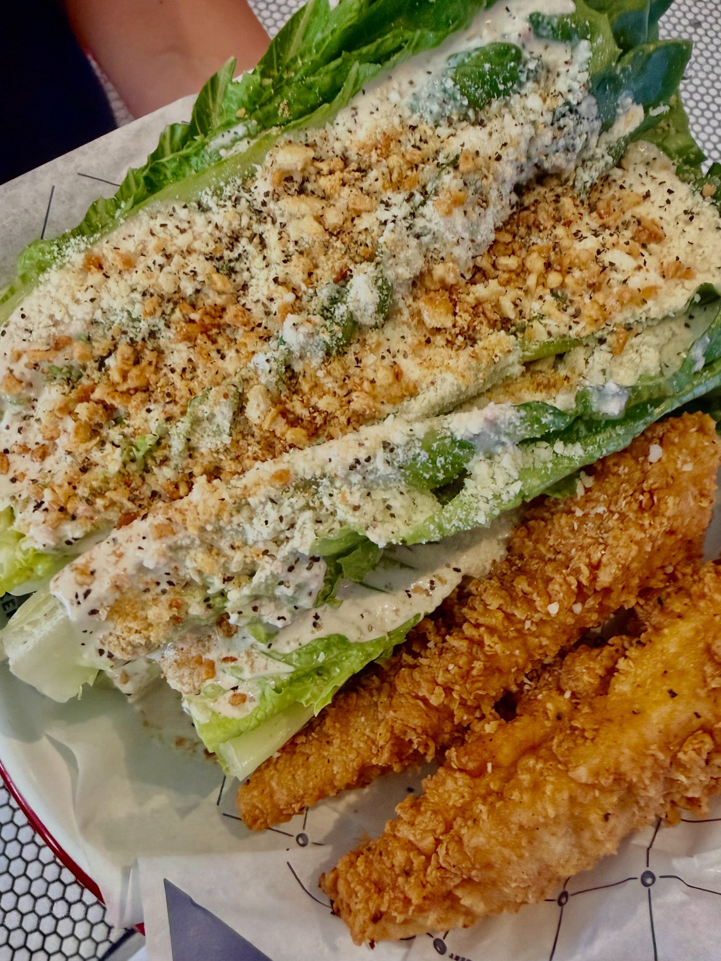 Nothing hits better in the summer than a Caesar salad. 

Two tenders, crunchy romaine hearts, parmesan, crispy garlic, house Caesar dressing, and breadcrumbs.

Sounds like you have lunch plans now.