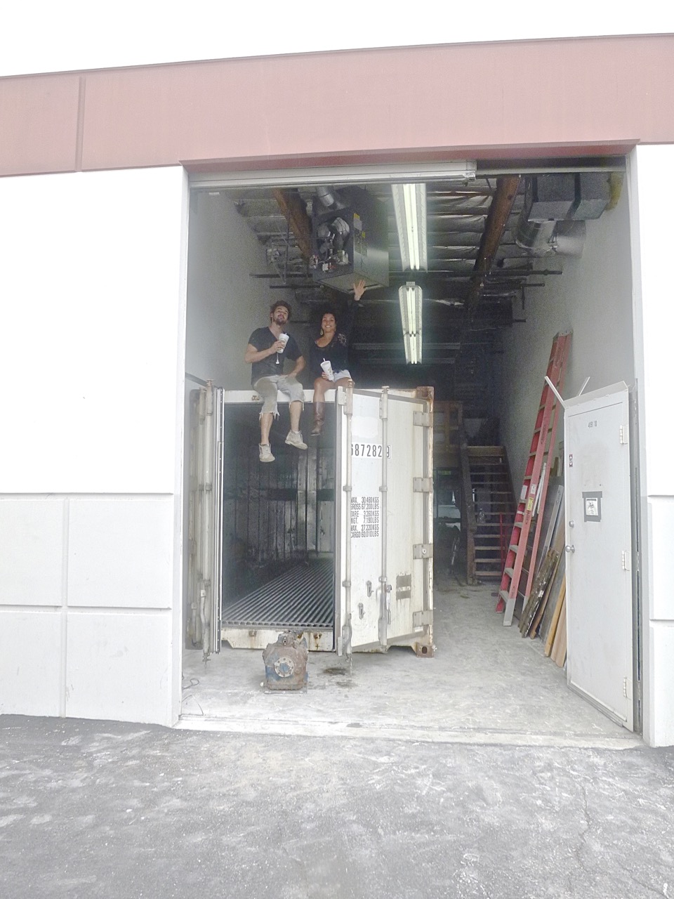  Lunch break: Nole Cossart and Rachna Hailey Sagar rest atop the newly installed 24' recyled refrigerated shipping container. 