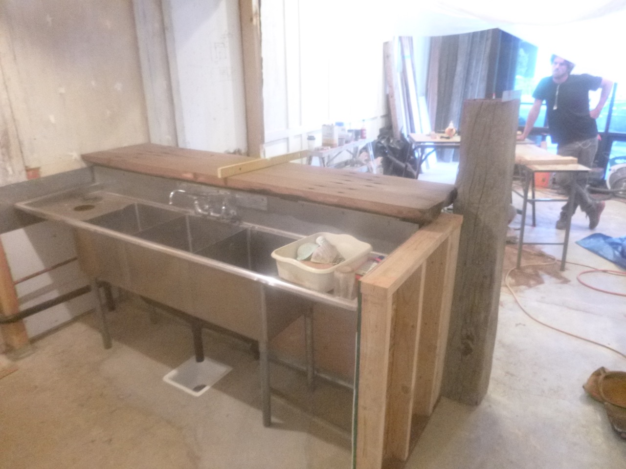 On the level: Nole ponders his handiwork. A recyled sink unit finds a permanent home.
