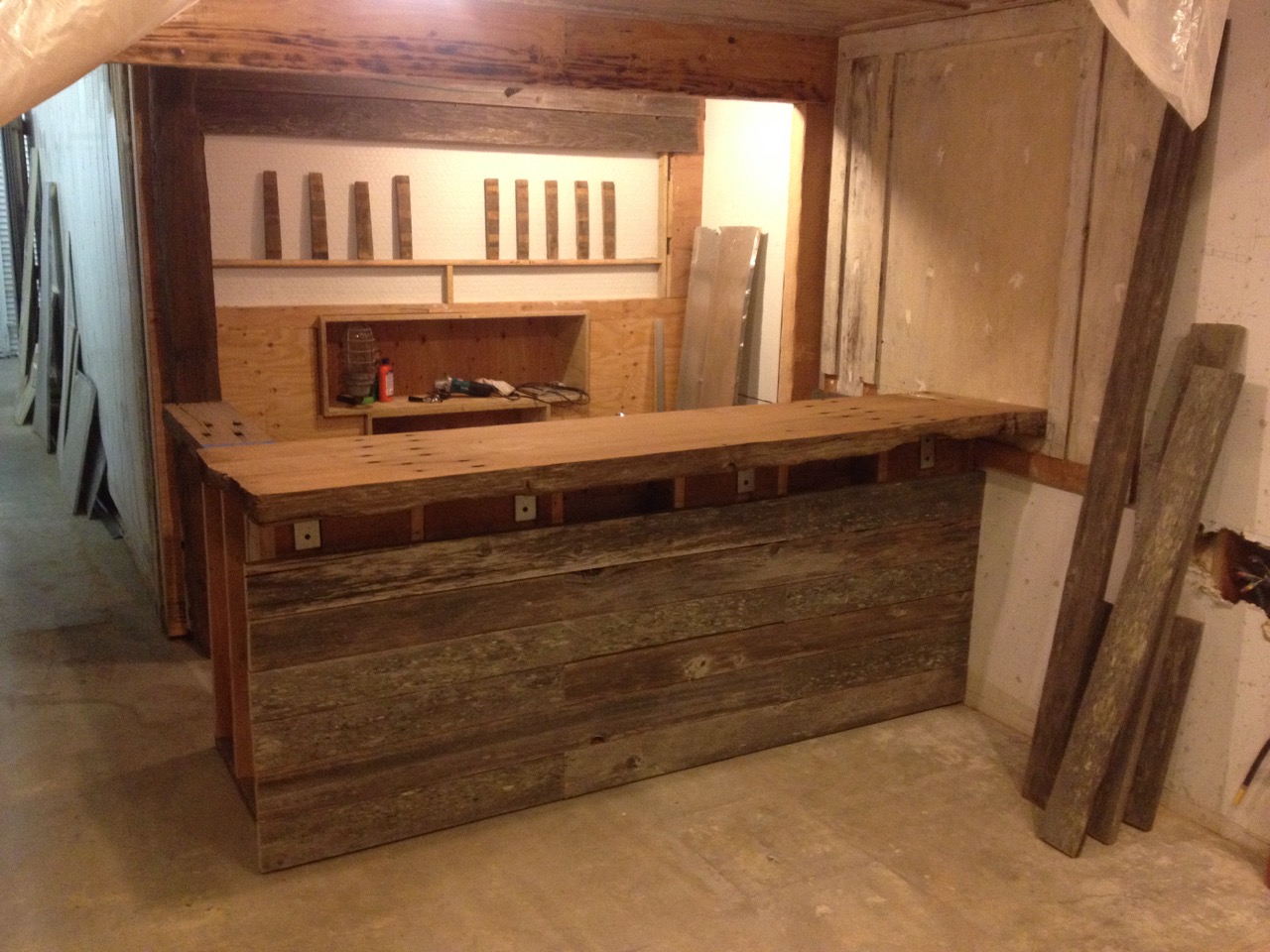  Staging:&nbsp;The taps are mocked up from old oak barrel staves,&nbsp;the face of the bar is salvaged pasture fencing. 