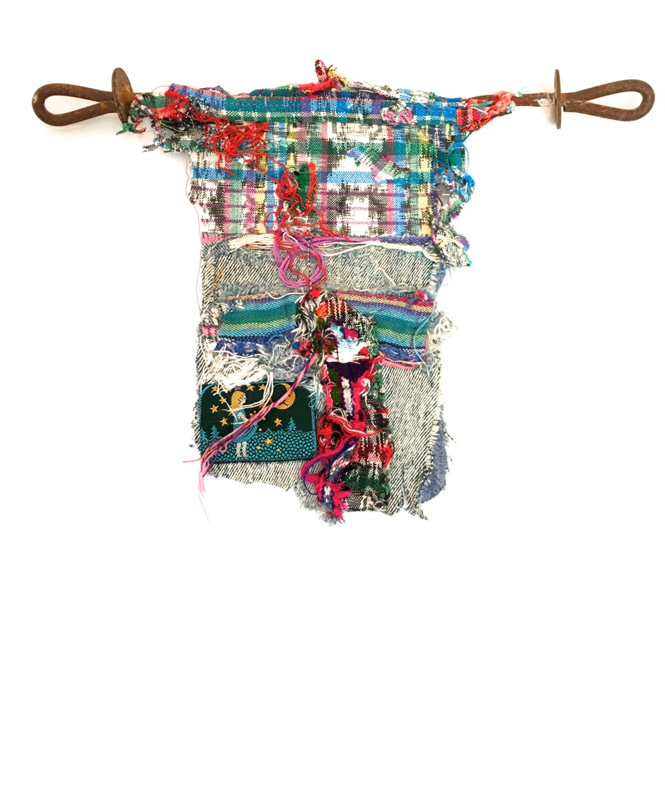 Patched toddler Recycled South American, India weavings, denim, label on rusty rebar 11½ x 8½ x 1” 2014, 2018