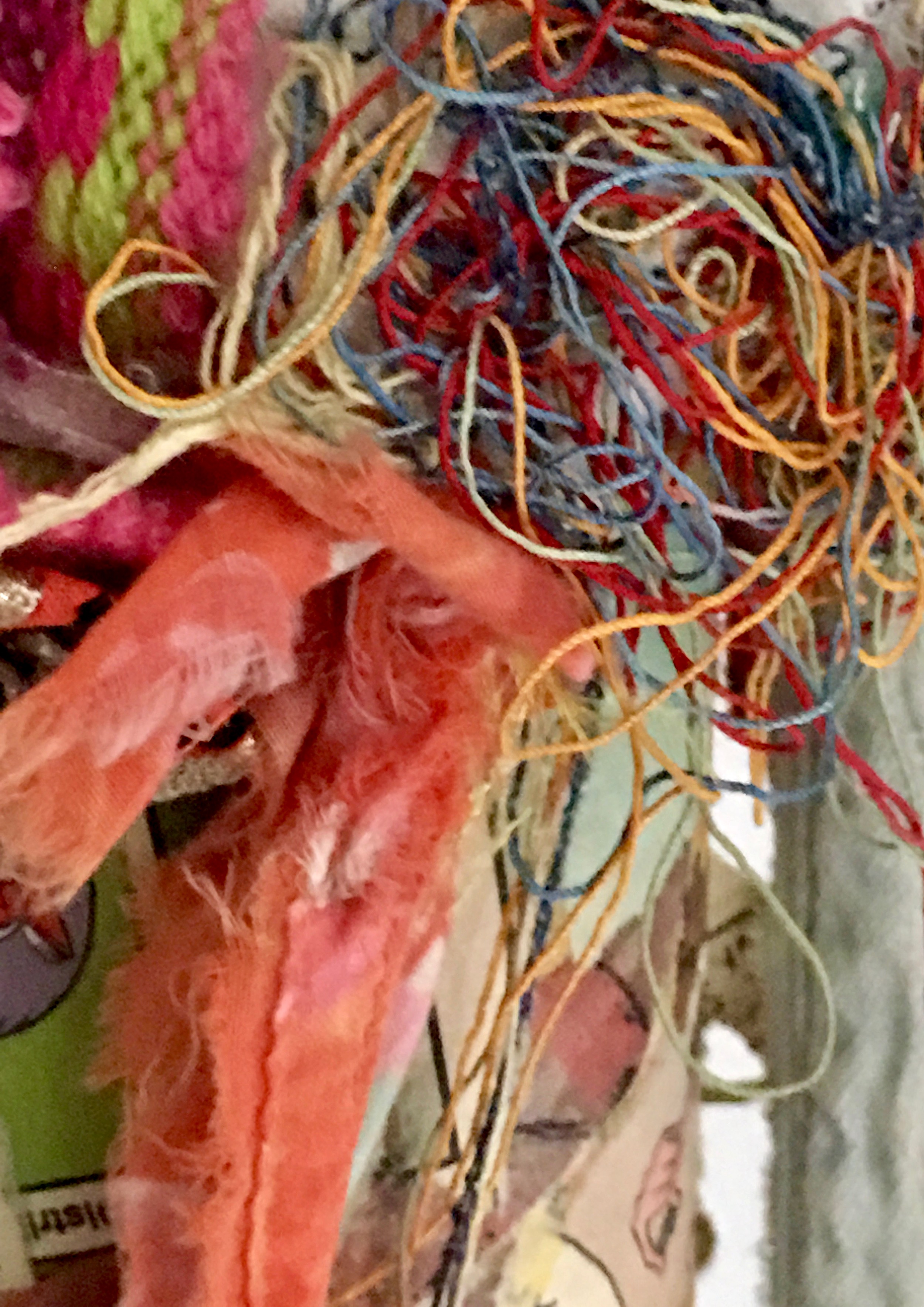 Oracle (Detail) Rust, textile, comics, thread, mirror, colored twine on industrial cardboard tube. Base: found tree-slice 22 x 8” 2015