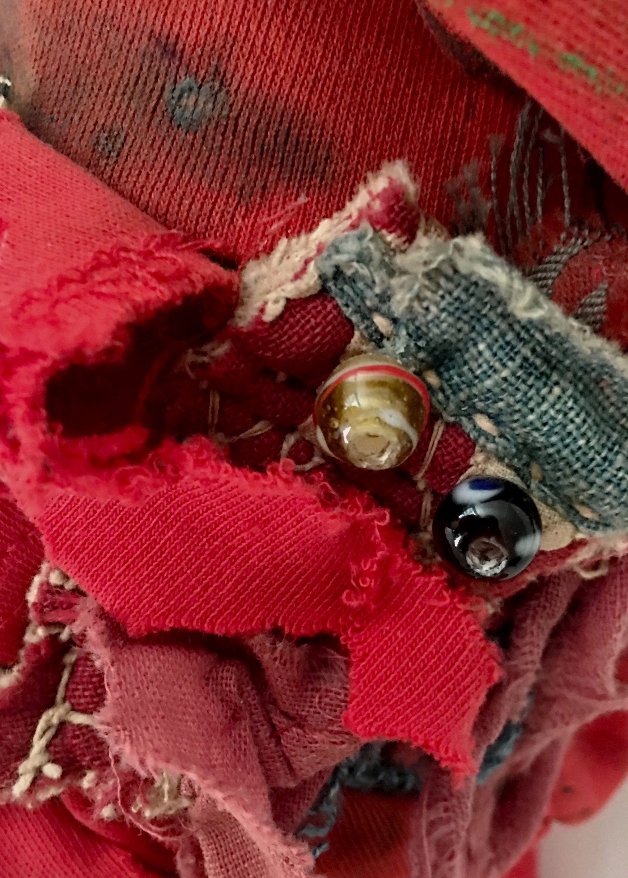 Red Rag Shaker with Amulets (Detail) Hand-painted red textile, antique Indian textile, buttons, threads, recycled textiles, acrylic on industrial cardboard tube, with hidden power amulets 14 x 8” round 2015