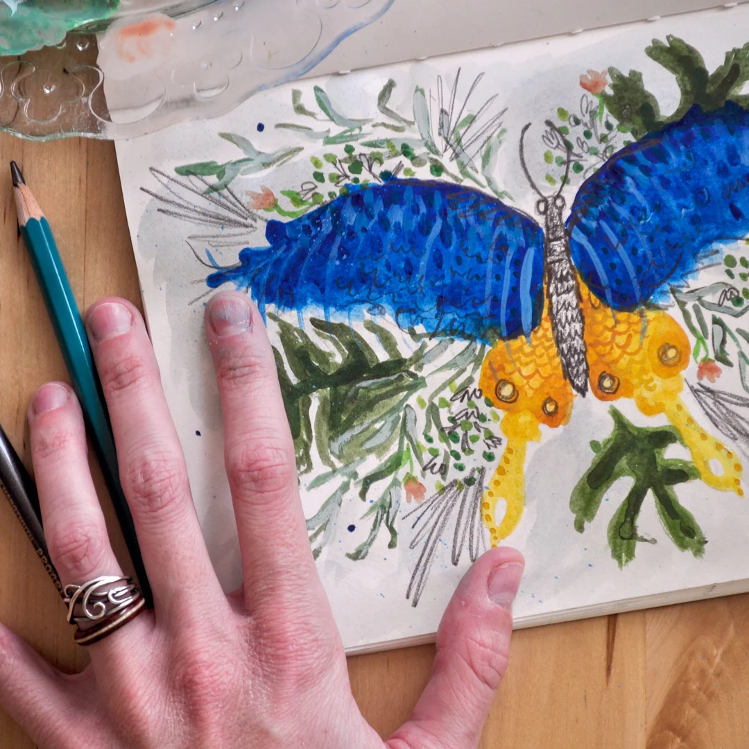 Butterfly_flatlay_withhand_web_square.jpg