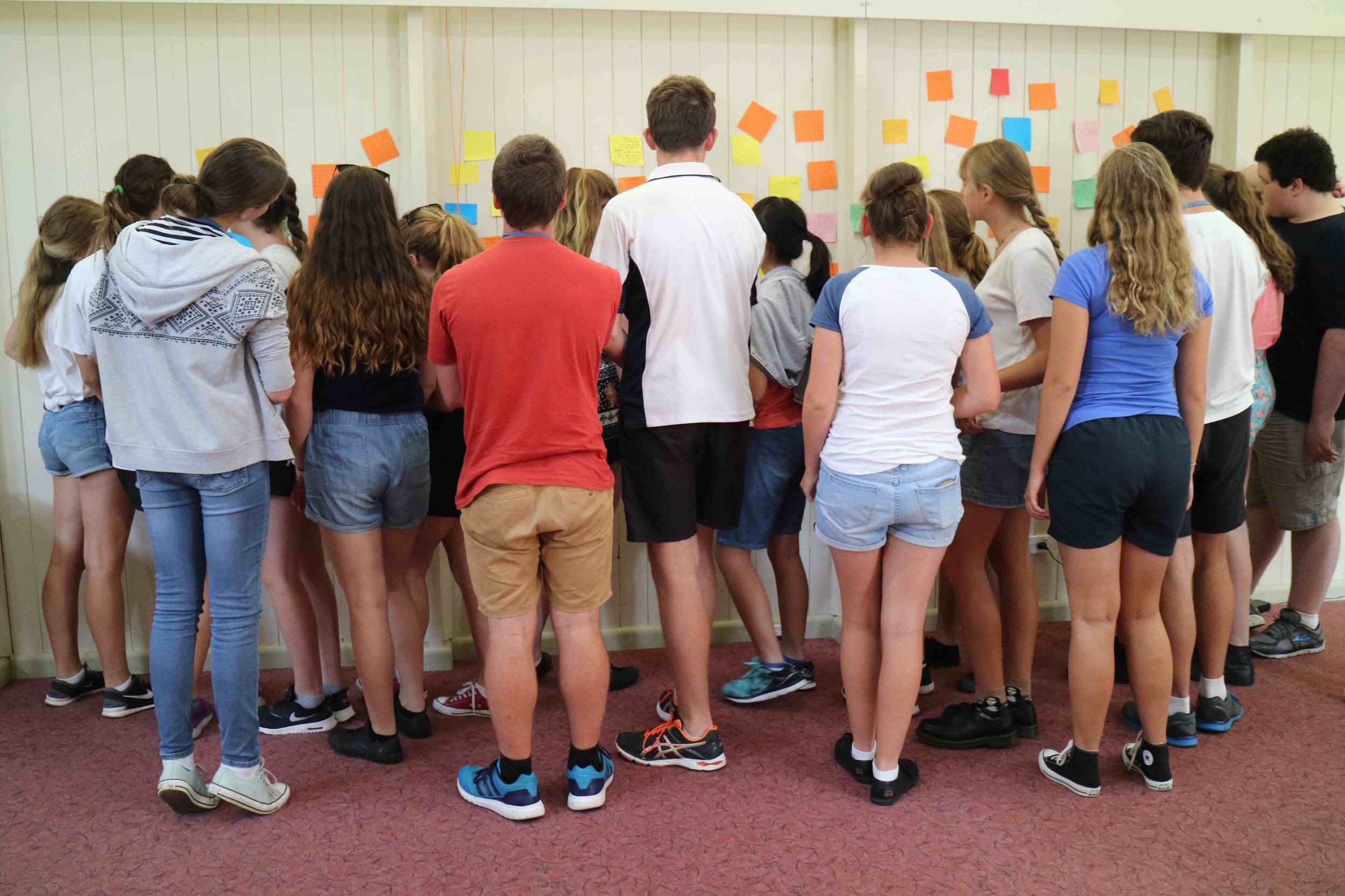 Students from Aurora College writing down ideas