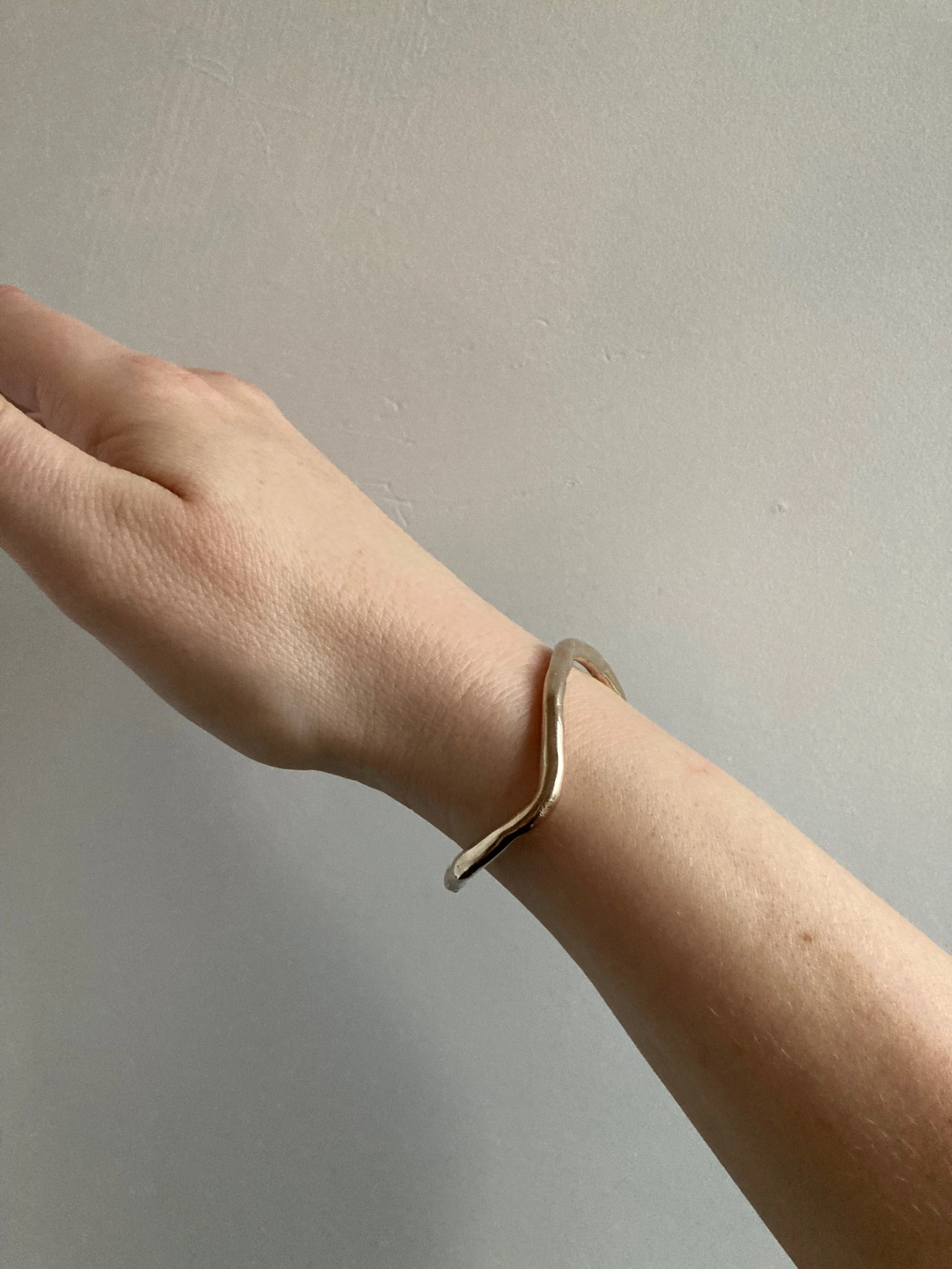 Curve cuff, bronze, side view.jpeg