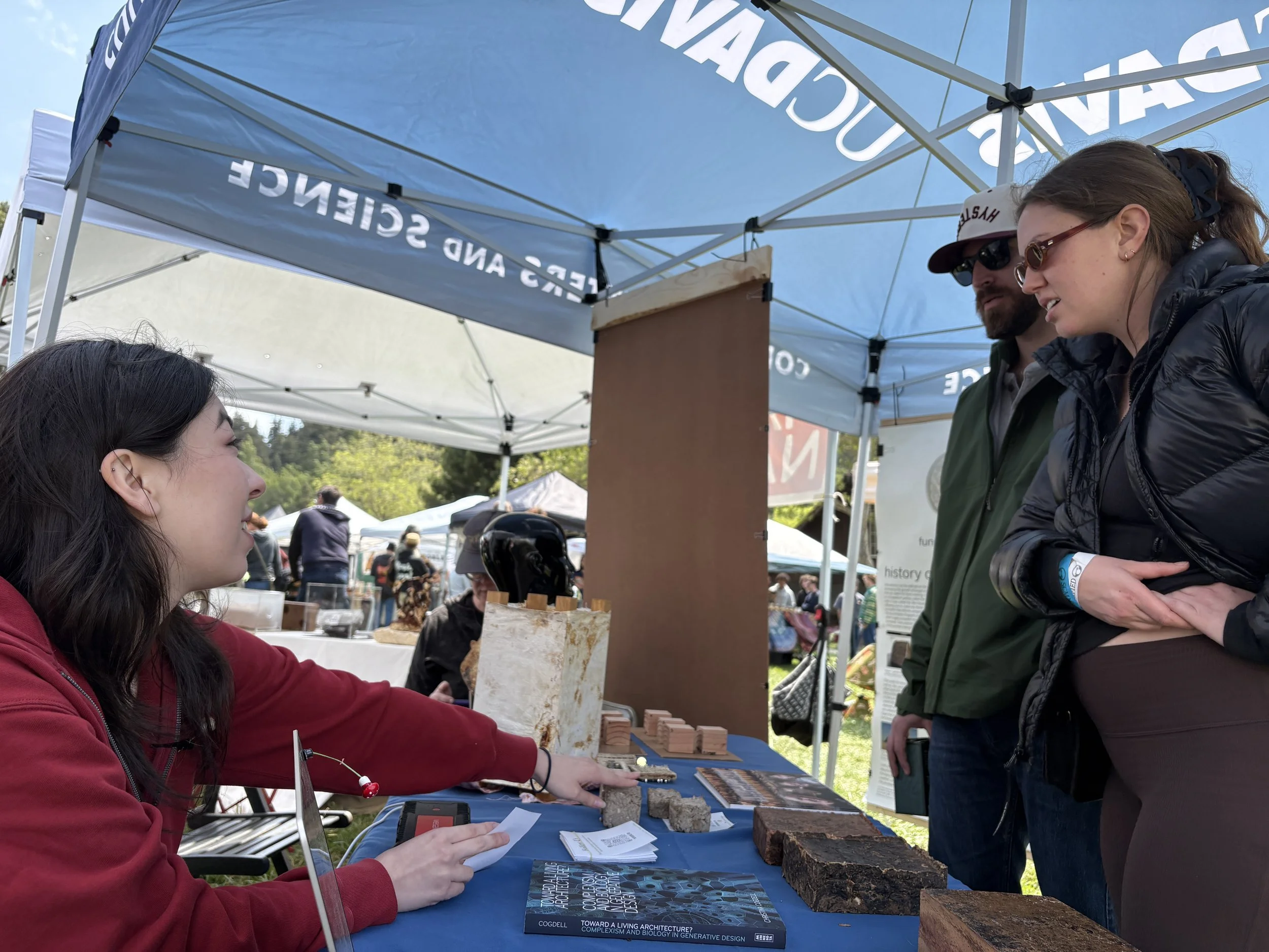 Megumi Konzen at booth talking with public.JPG