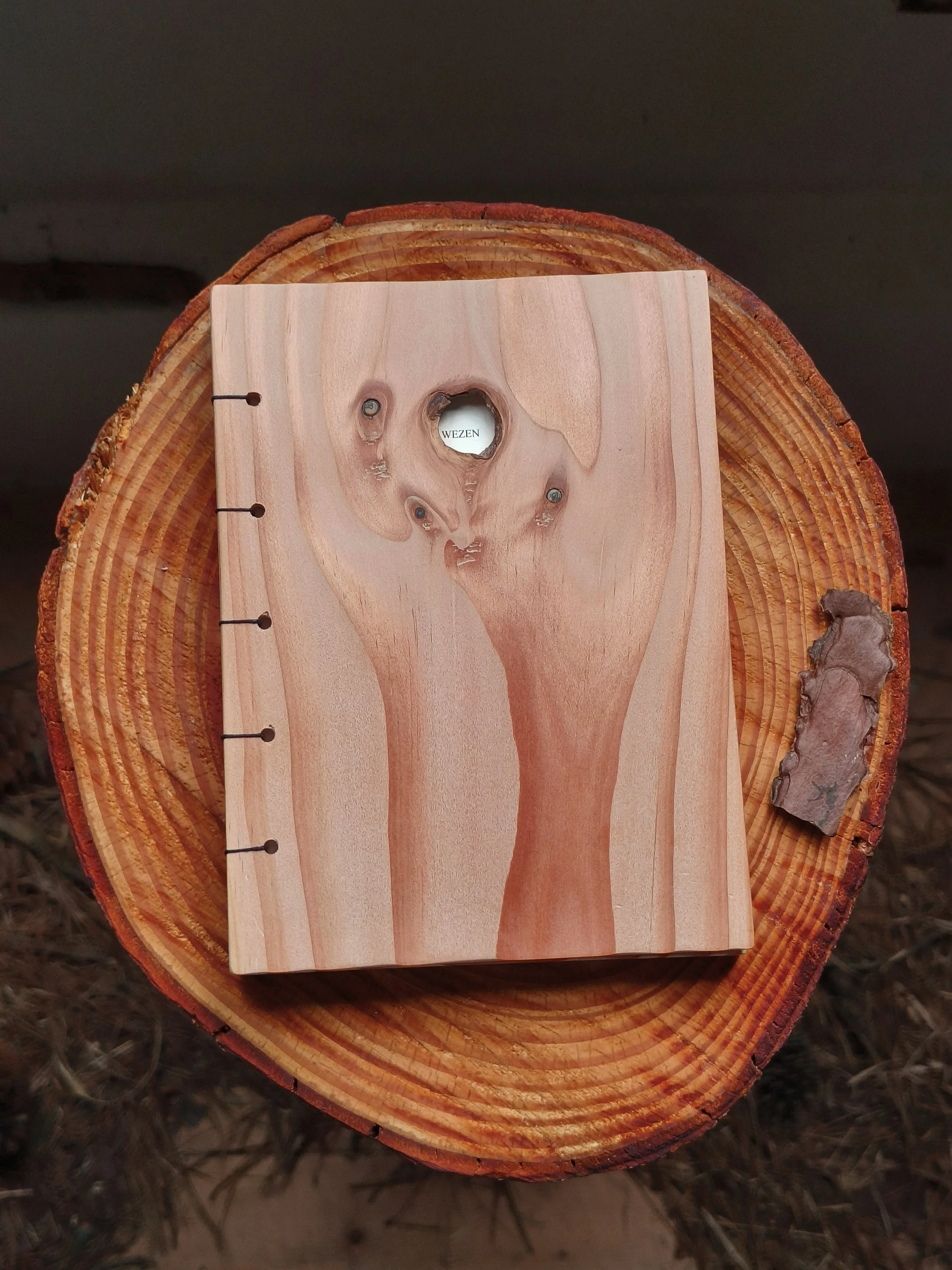  For this challenge, I also created my own poetry bundle—one where all the senses are triggered. I decided to use wood as a hard cover for my bundle, bringing feeling and smell into the reading experience. It also felt right to bring the paper I prin