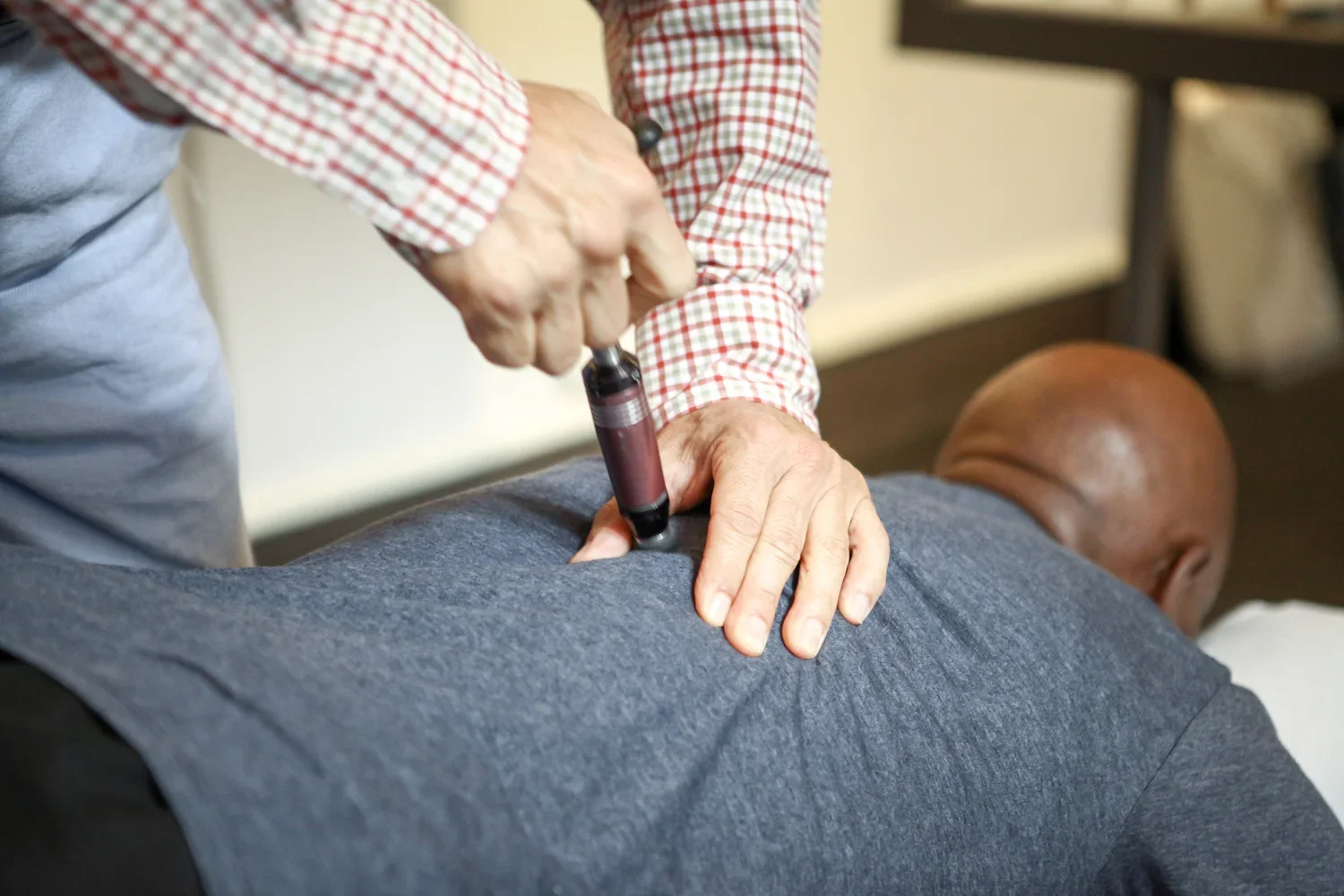 Healthcare practitioner performing acupuncture on a patient's back