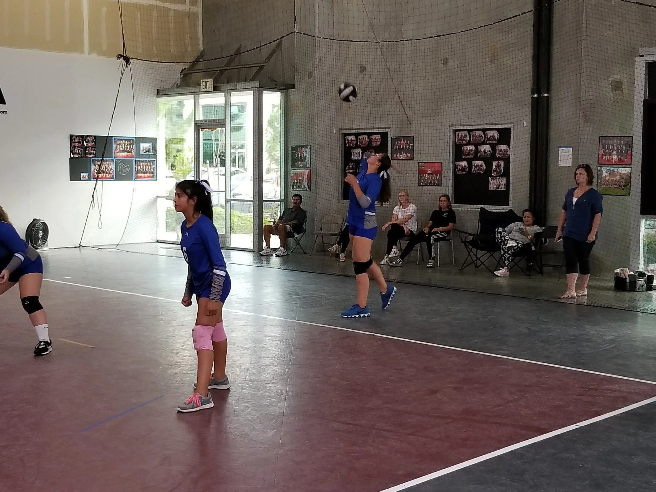 Ashlin Smith attacks one of her dominant serves in game three, which put BHS ahead in the match. Mia Madrid (left) is at the ready, as the Legion cheering section looks on from back court.