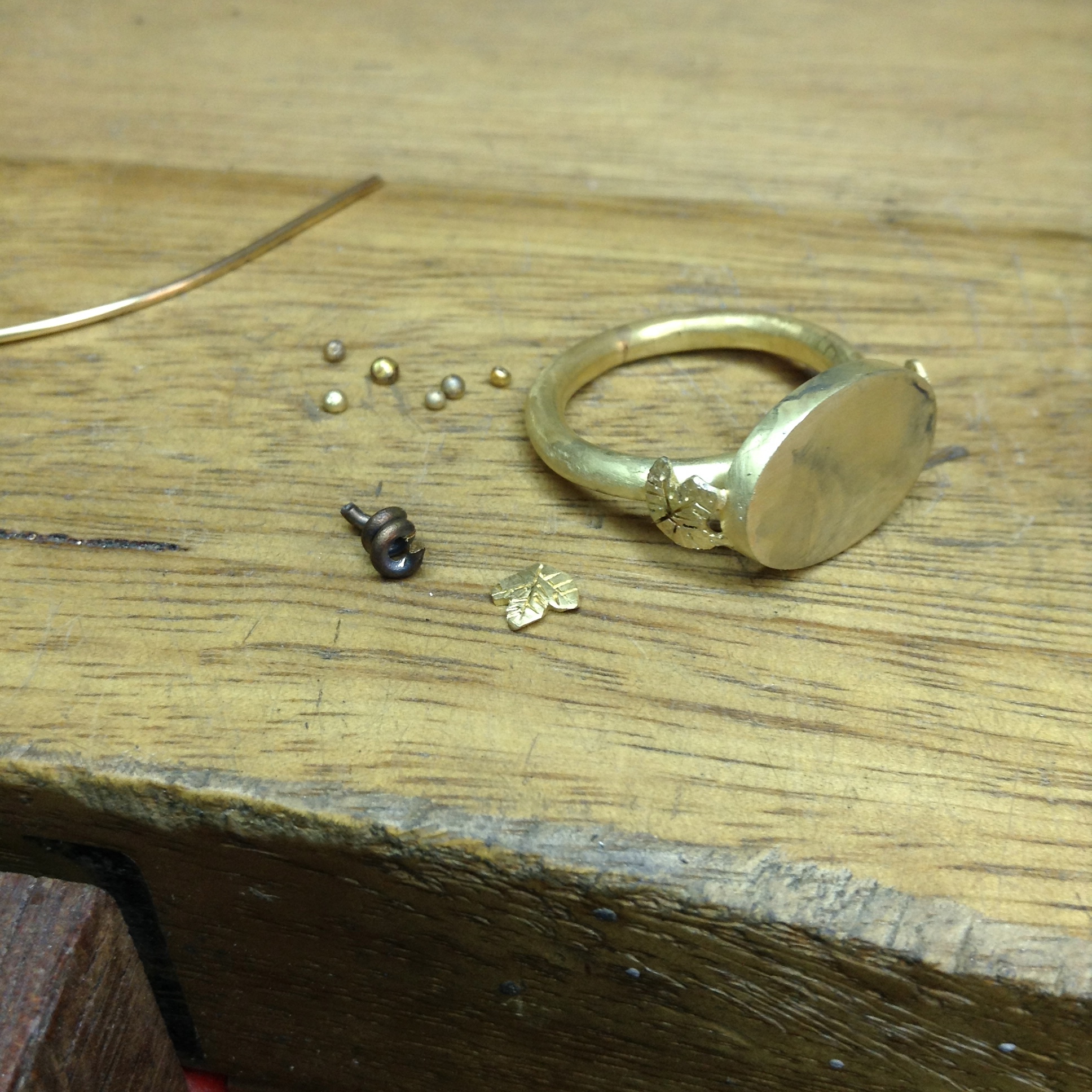 ring in production, assembling the grape leaves and vine for the shoulders