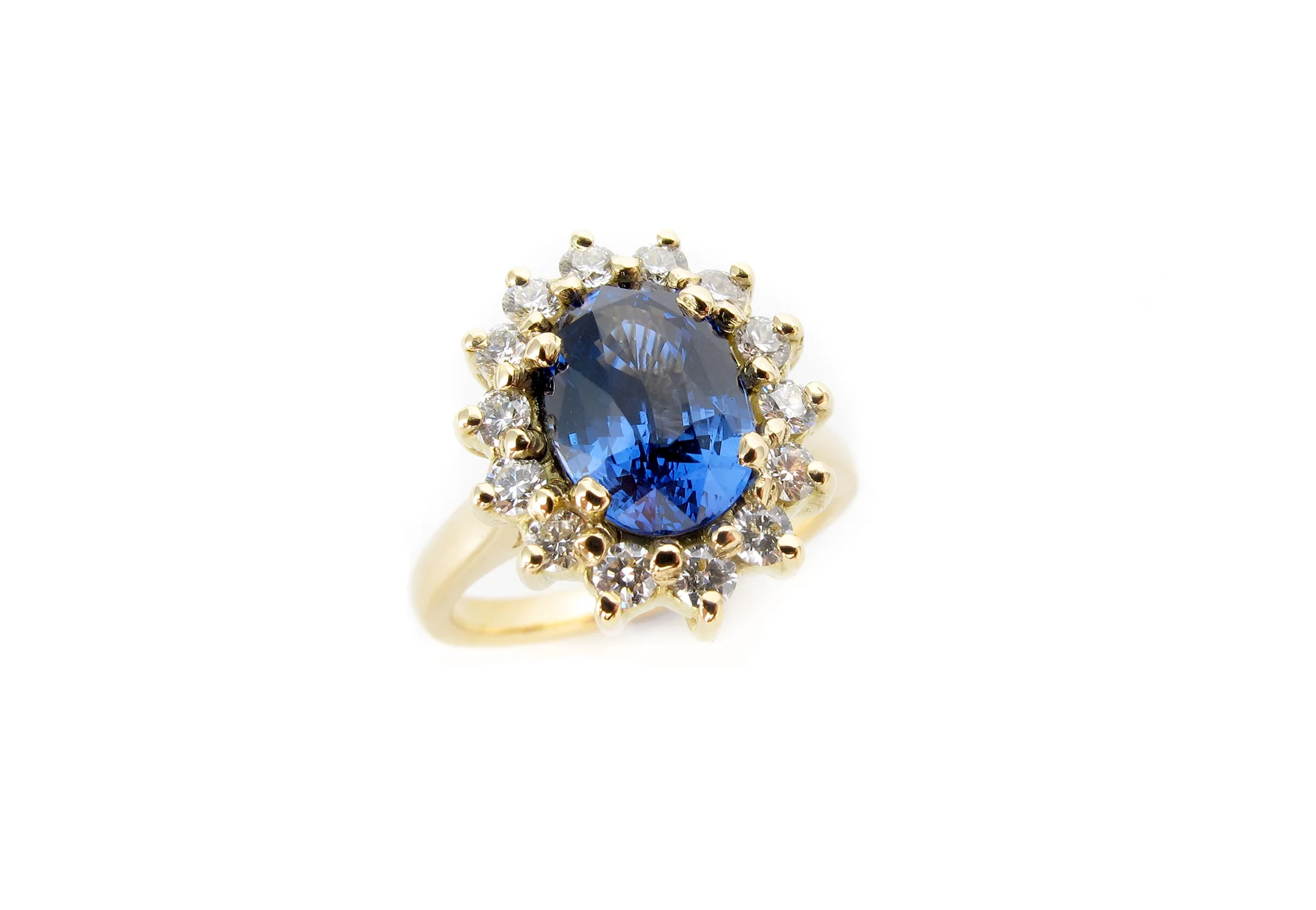 Ceylon sapphire with diamond halo, traditional cluster in 18ct yellow gold