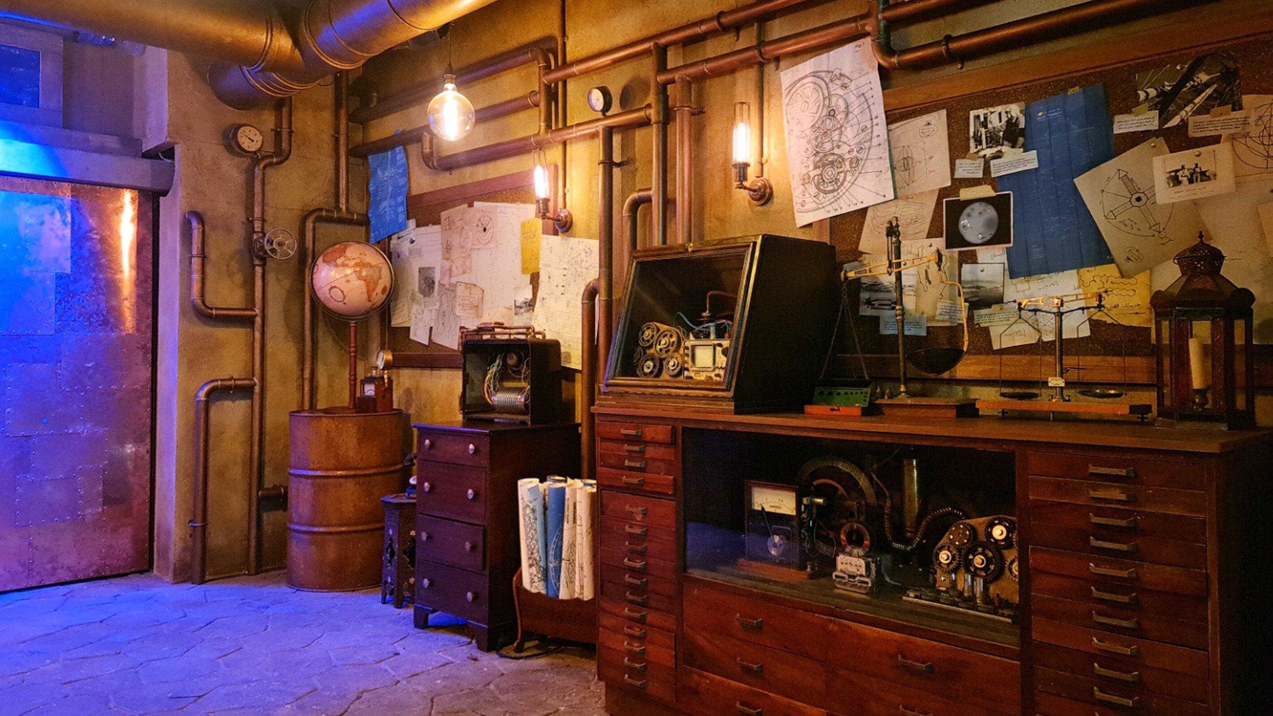 One angle of the custom fit-out created for the line for a roller coaster queue in Doha, Qatar. It emulates a mad victorian professors laboratory complete with moving contraptions and devices and scientific tools, the floor is custom stamped concrete