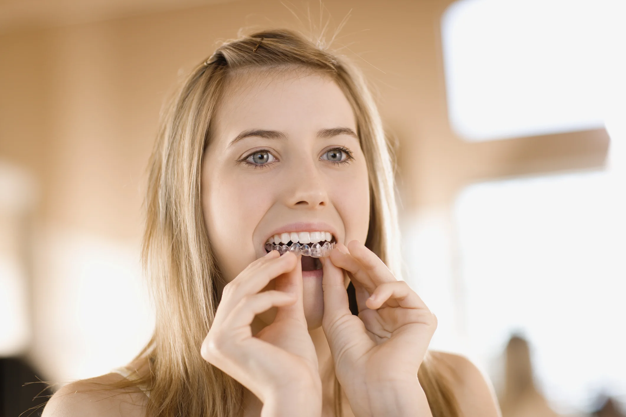 Take home whitening involves using trays like the ones she is using