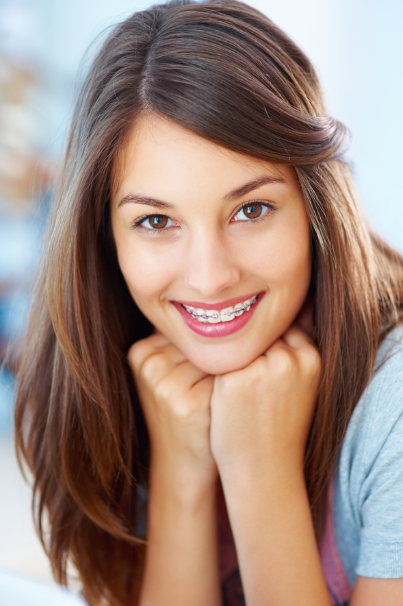 Girl smiling with pink braces