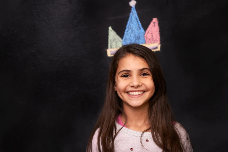 Child with crown on chalkboard
