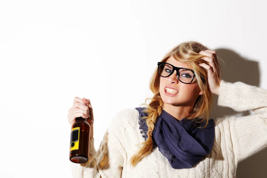 girl holding bottle with headache