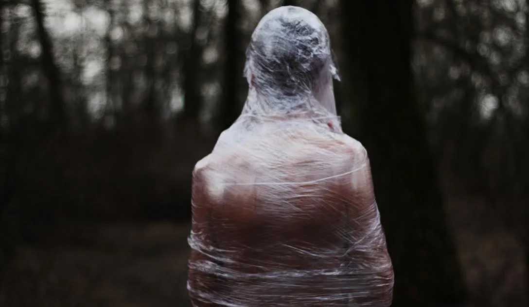 A man covered in foil dies. The nature covered in garbage dies too.