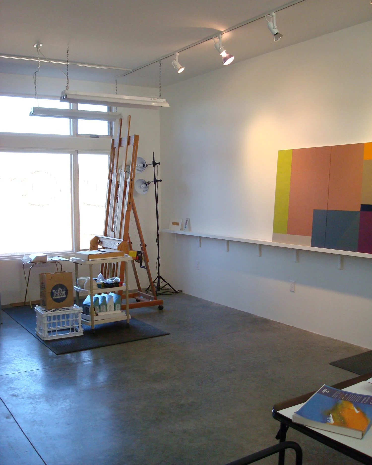 Danielle Shelley's easel with north window, plus painting shelf and work table, in new studio.