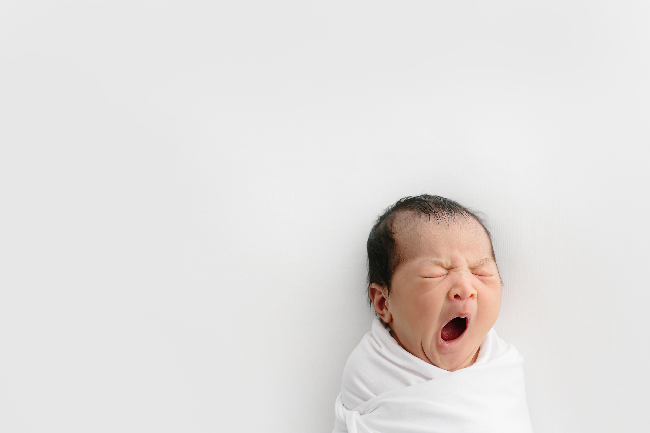 Baby yawning during newborn photography session in Melbourne