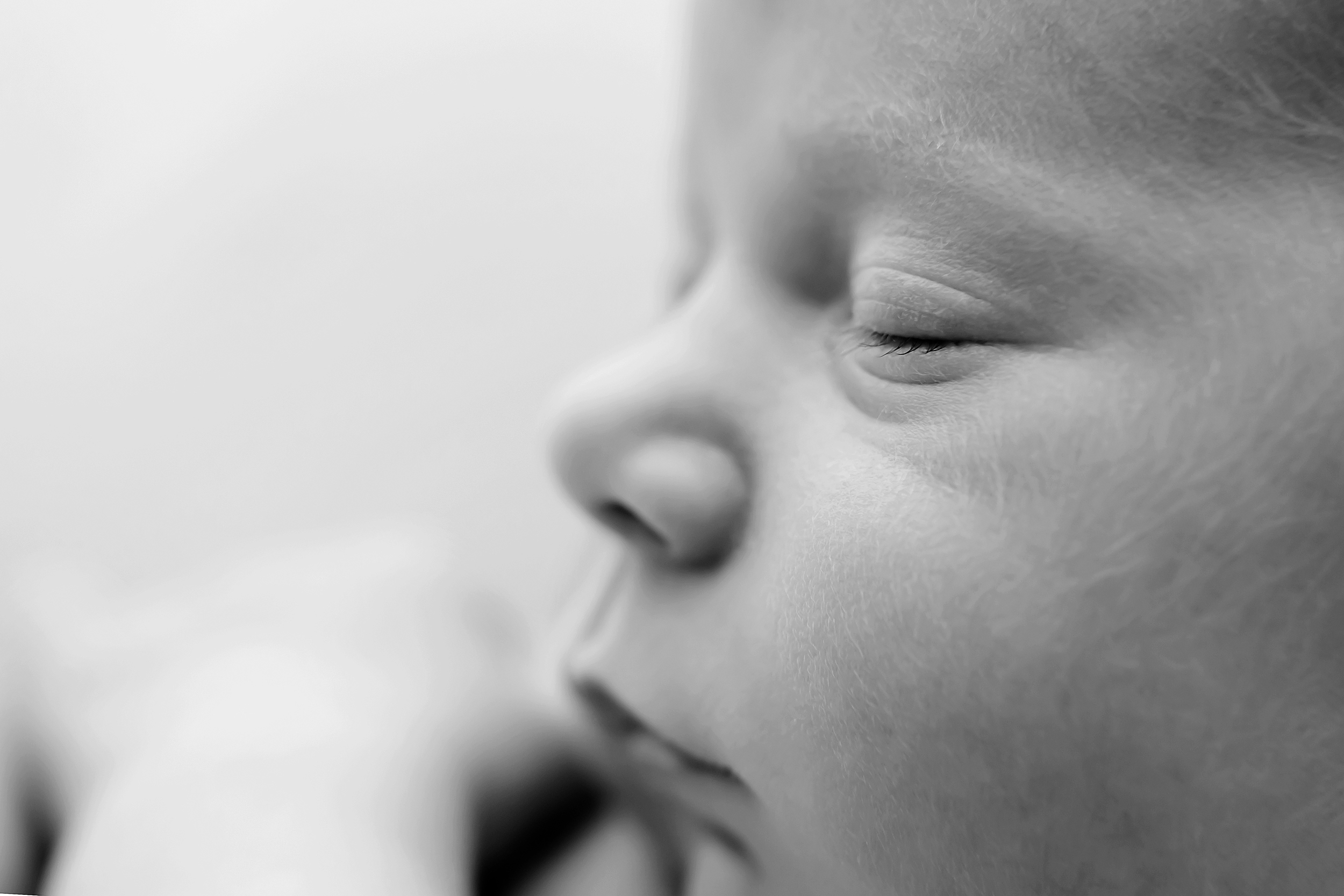 Close up baby photo in black and white showing a baby sleeping during a newborn photography session in Melbourne