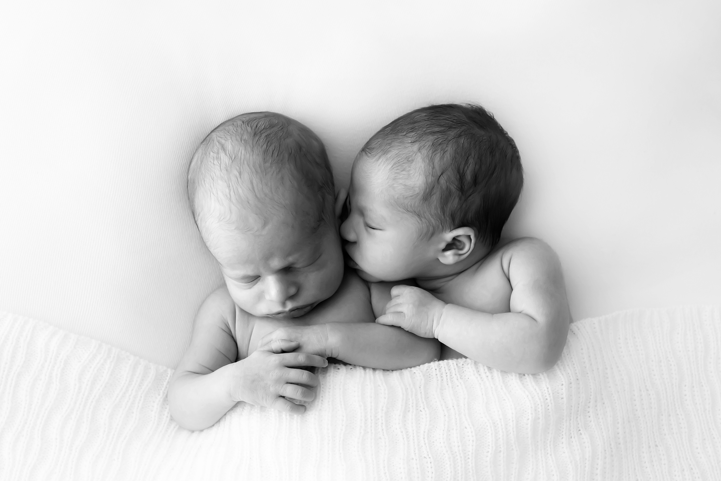 A black and white photo of baby twins taken during their newborn photography session in Melbourne by Monique Graham Photography