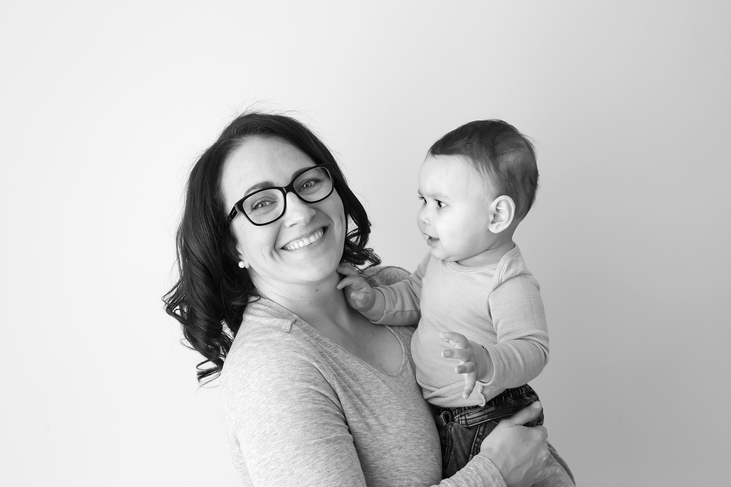 Mum holding her son in black and white at their family photography session in Melbourne natural light studio.