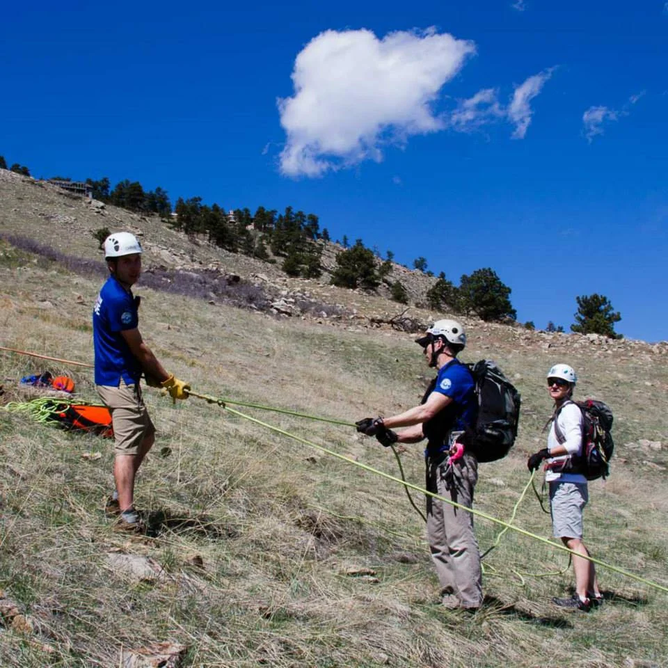 Members of Rocky Mountain Rescue Group man a brake / lowering station during the paraglider rescue operation in Boulder, Colorado. 