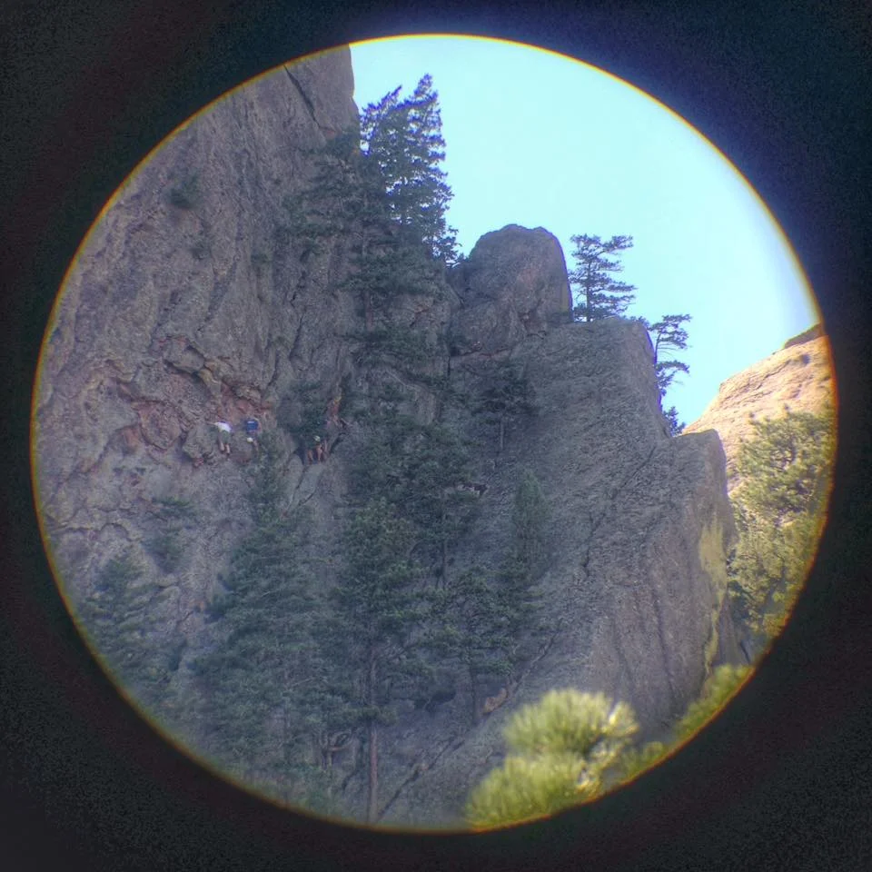The stuck party (wearing white) and rescuers (wearing blue) as seen through a spotting scope at the Bluebell Shelter.
