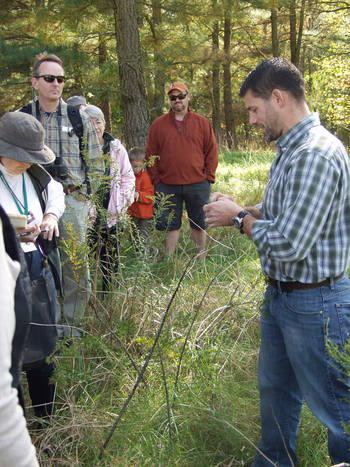 Dr. Schindler identifying a plant at Adkins Arboretum