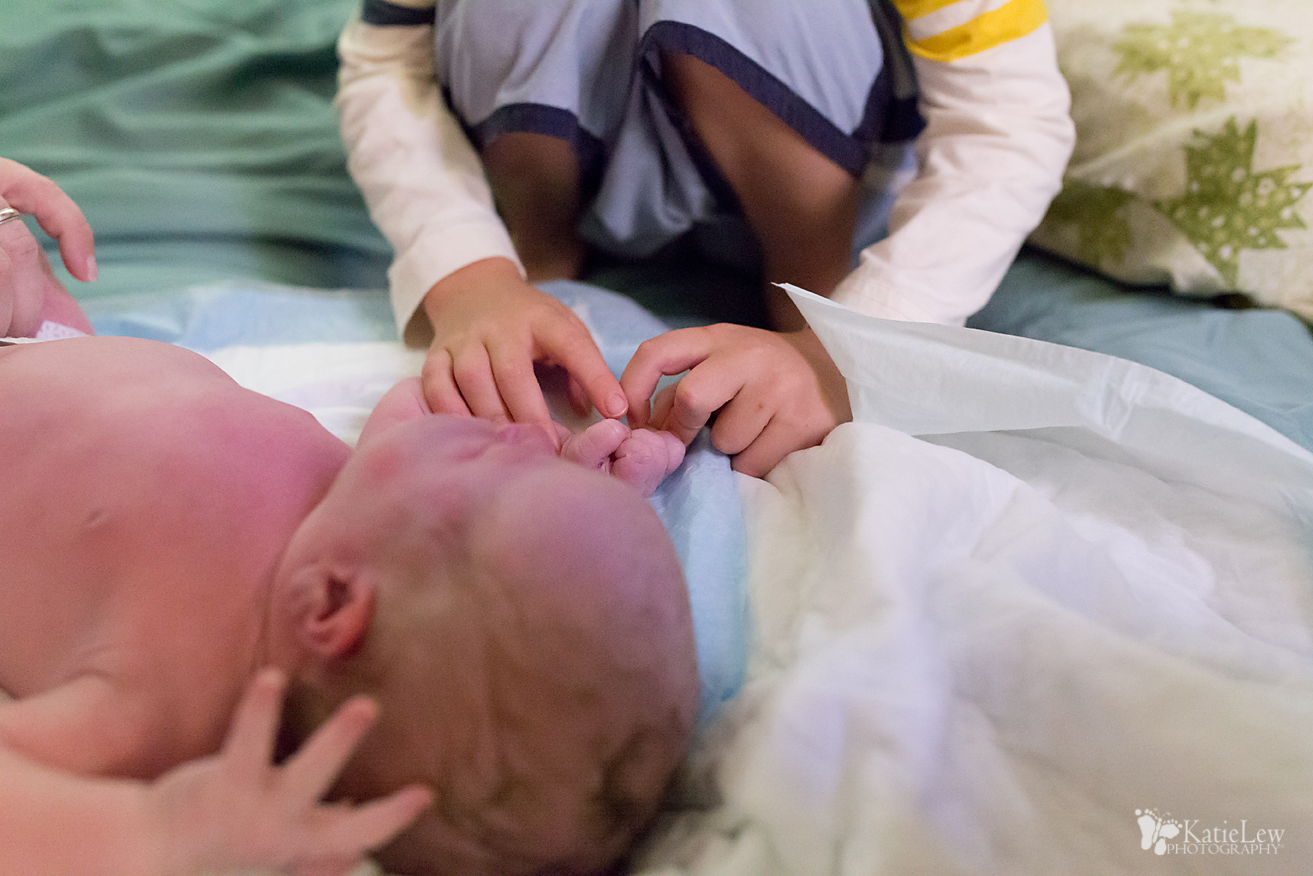 Big brother counting to make sure he had all his fingers and toes.