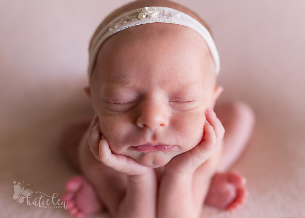 A close up of this twin in the newborn froggy pose