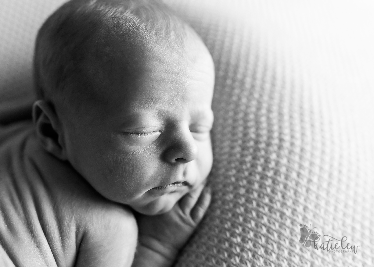 black and white image of a baby girl sleeping soundly