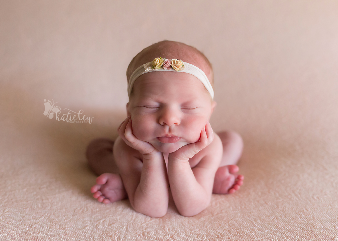 Baby hannah lying in the newborn froggy pose